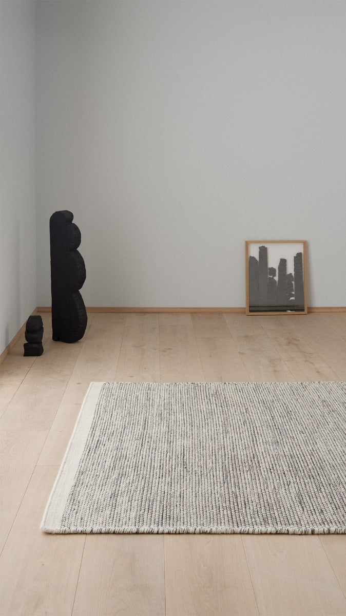 plain cream and black wool rug