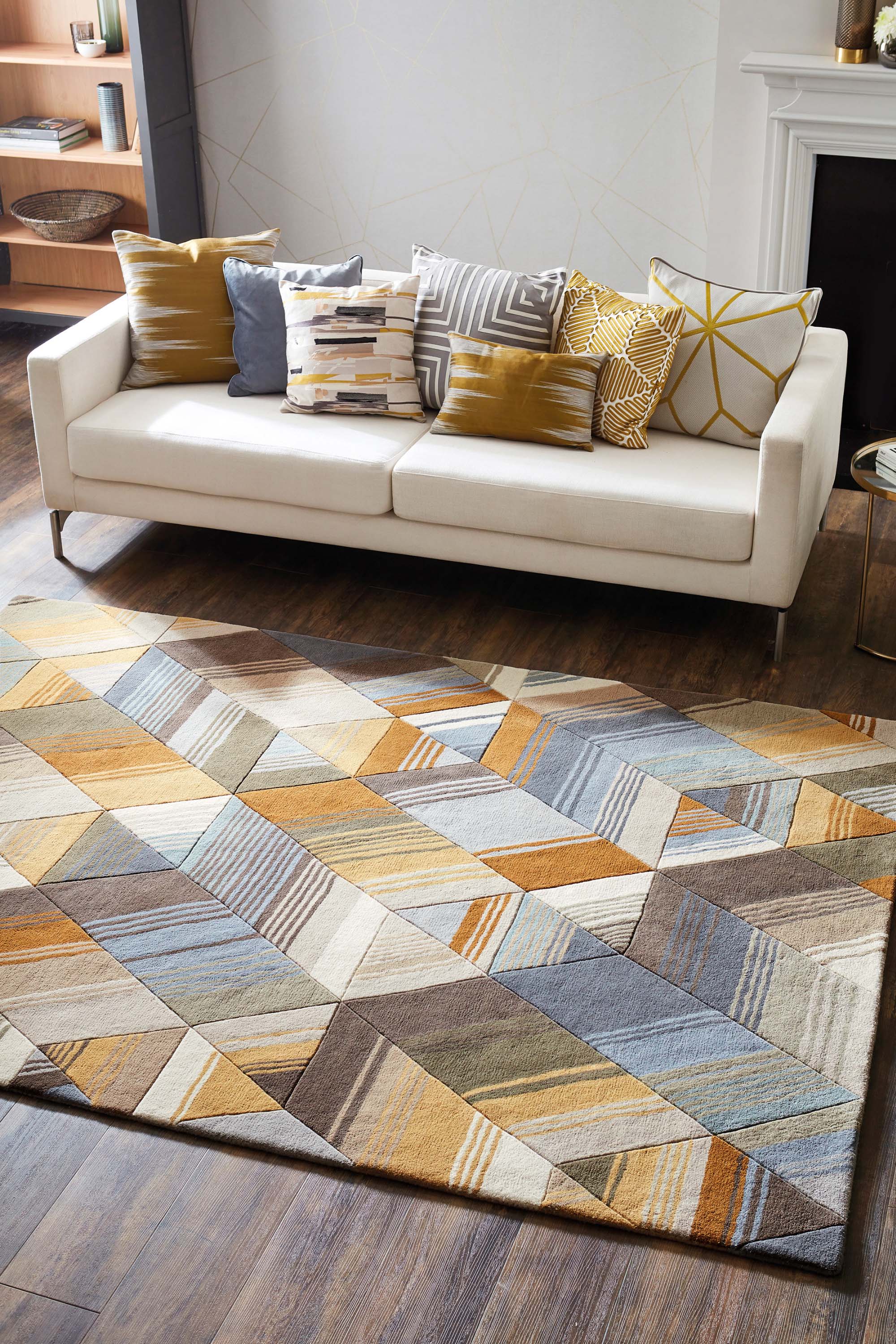 Harlequin rug with a multi-directional stripe design in grey and mustard yellow