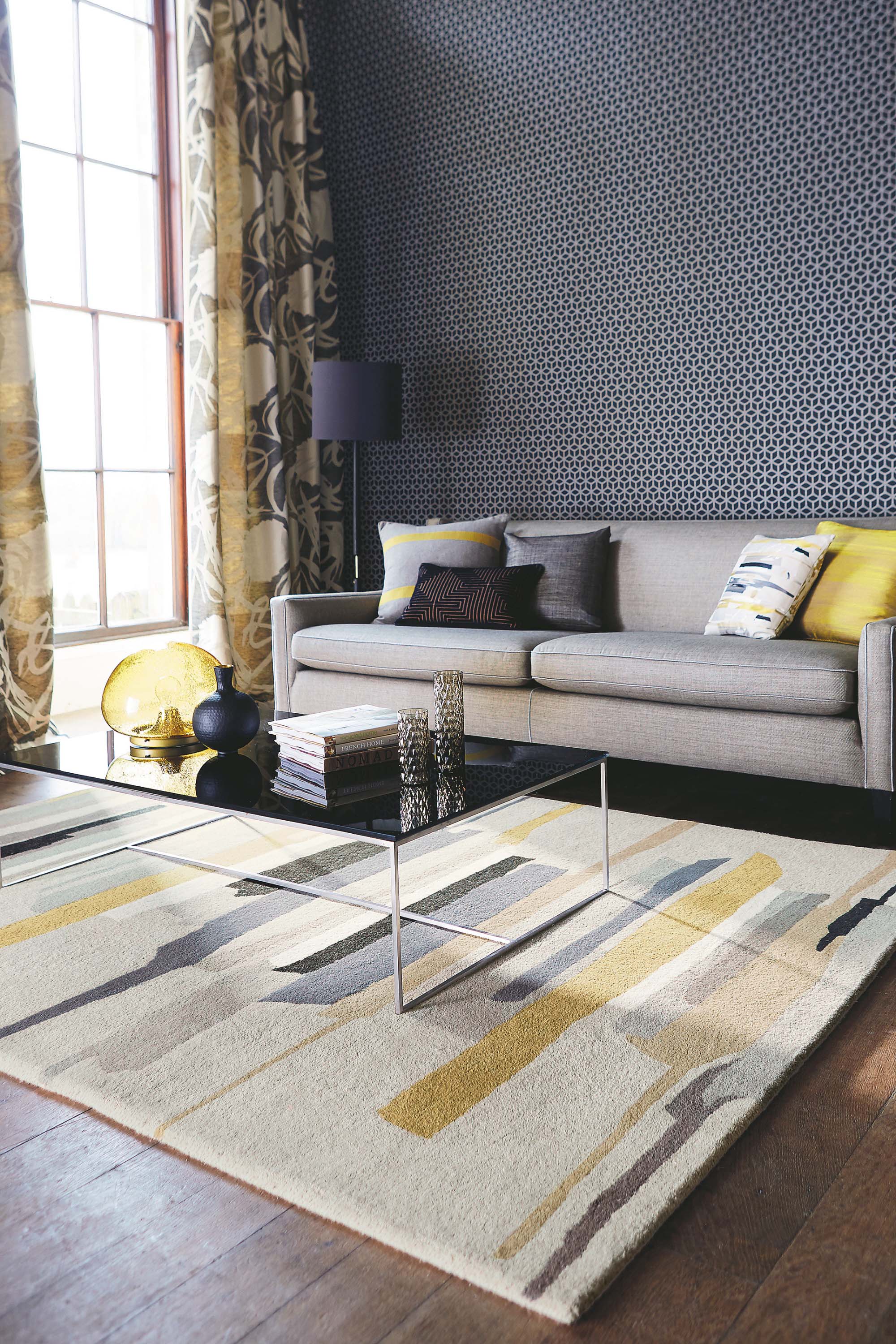 Rectangular white wool rug with pink, yellow, purple and green flowers and leaves