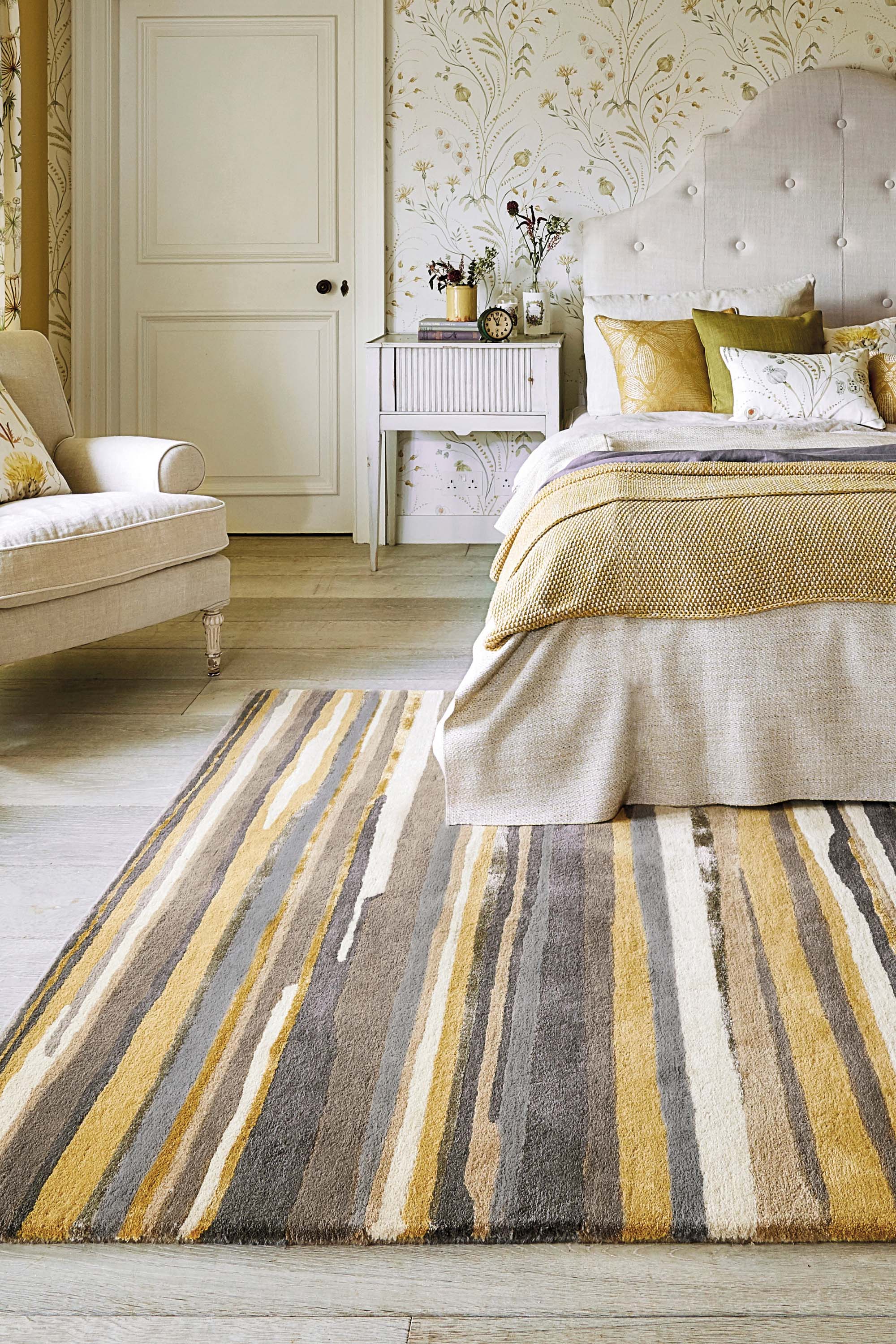 Rectangular rug with abstract stripe pattern in beige, brown, cream and gold hues
