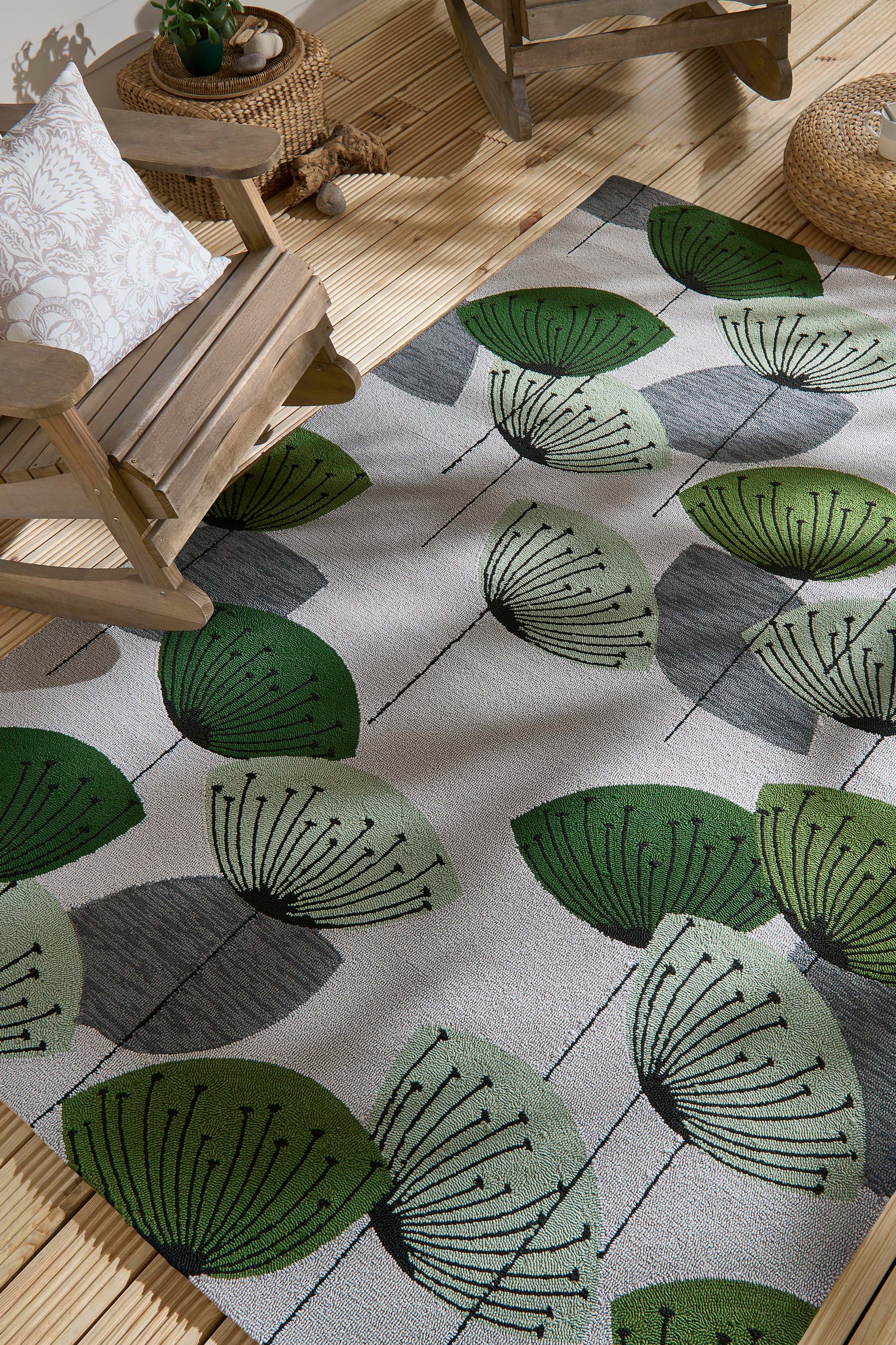 green and grey indoor/outdoor rug with dandelion pattern