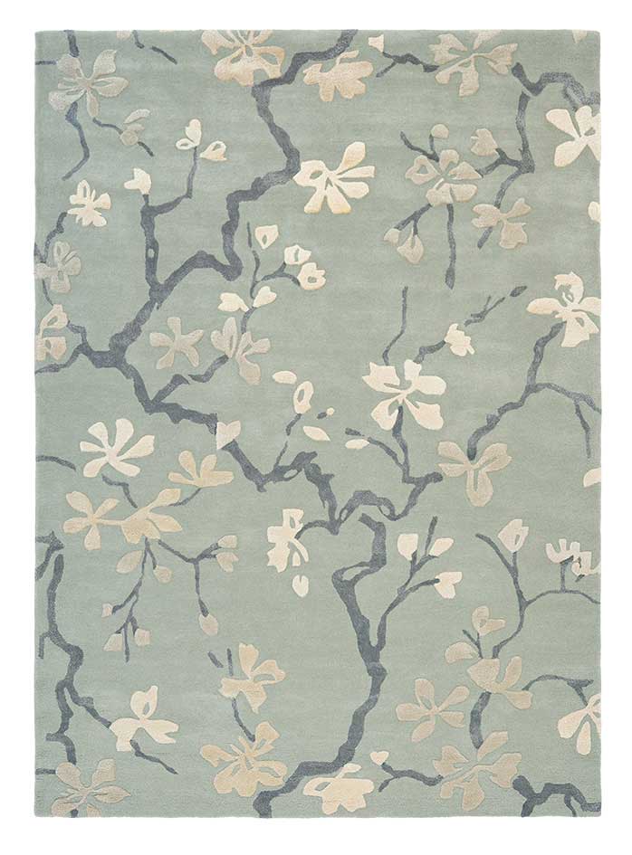 Rectangular blue rug with dark blue branch design and white flowers and leaves
