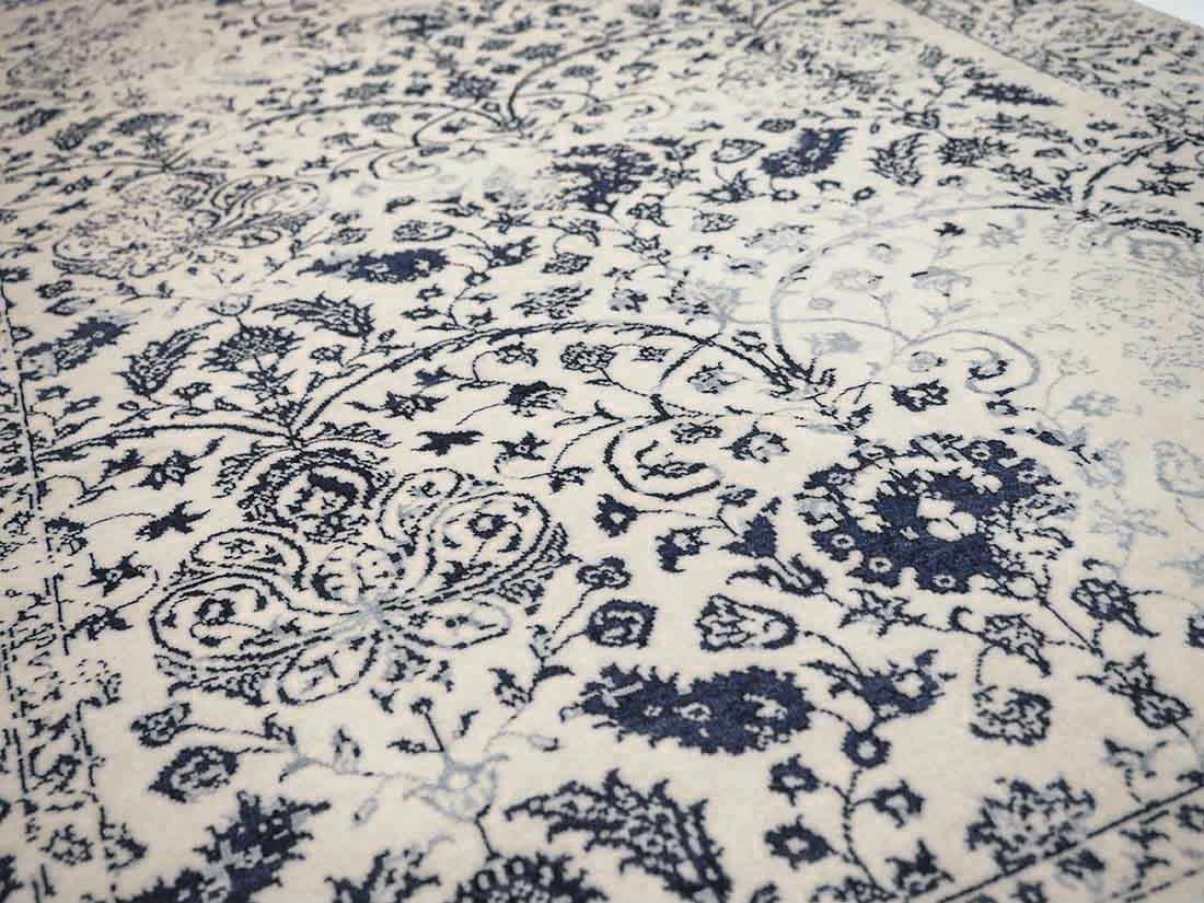 cream and blue oriental rug with a floral design