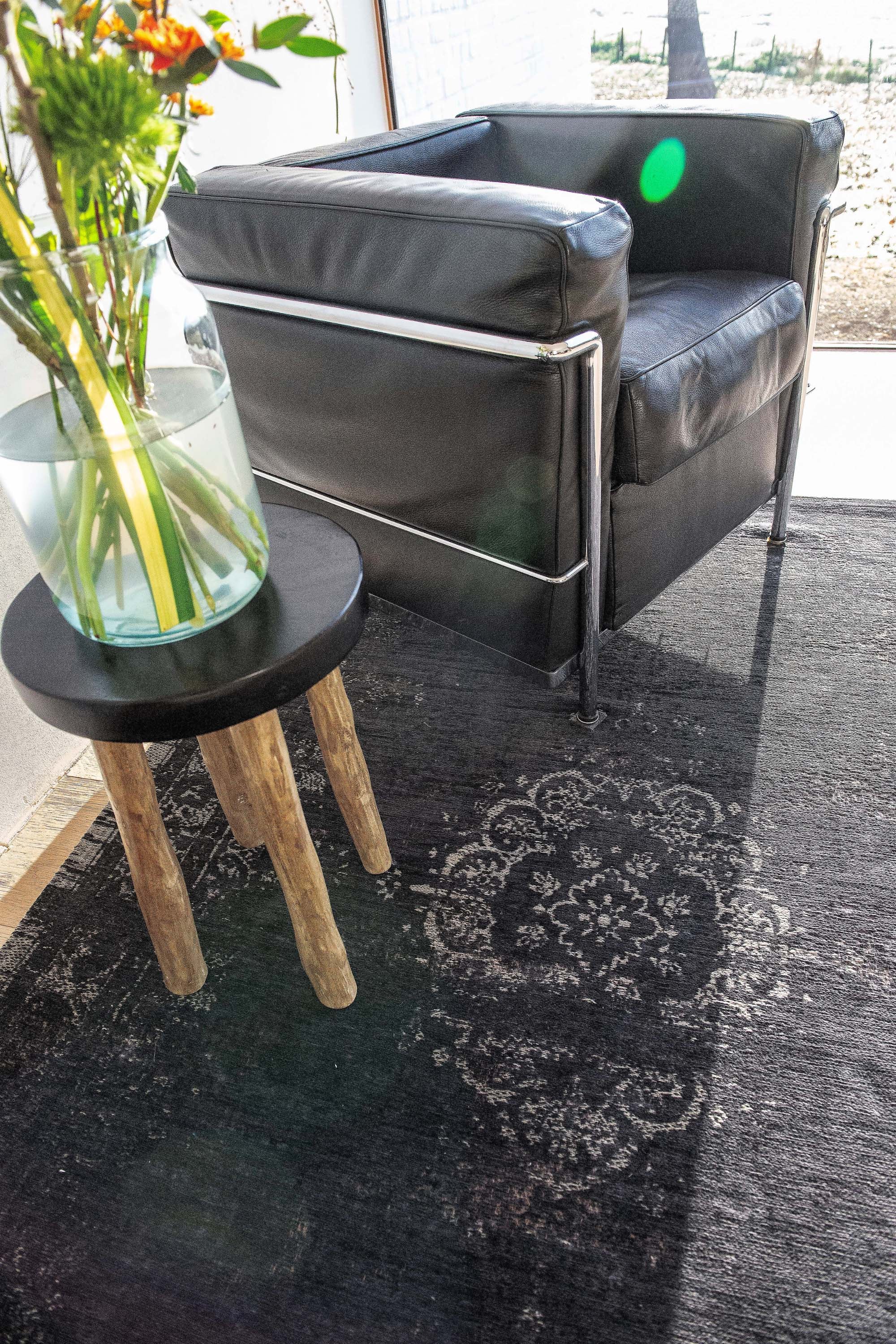 Black flatweave rug with faded persian design