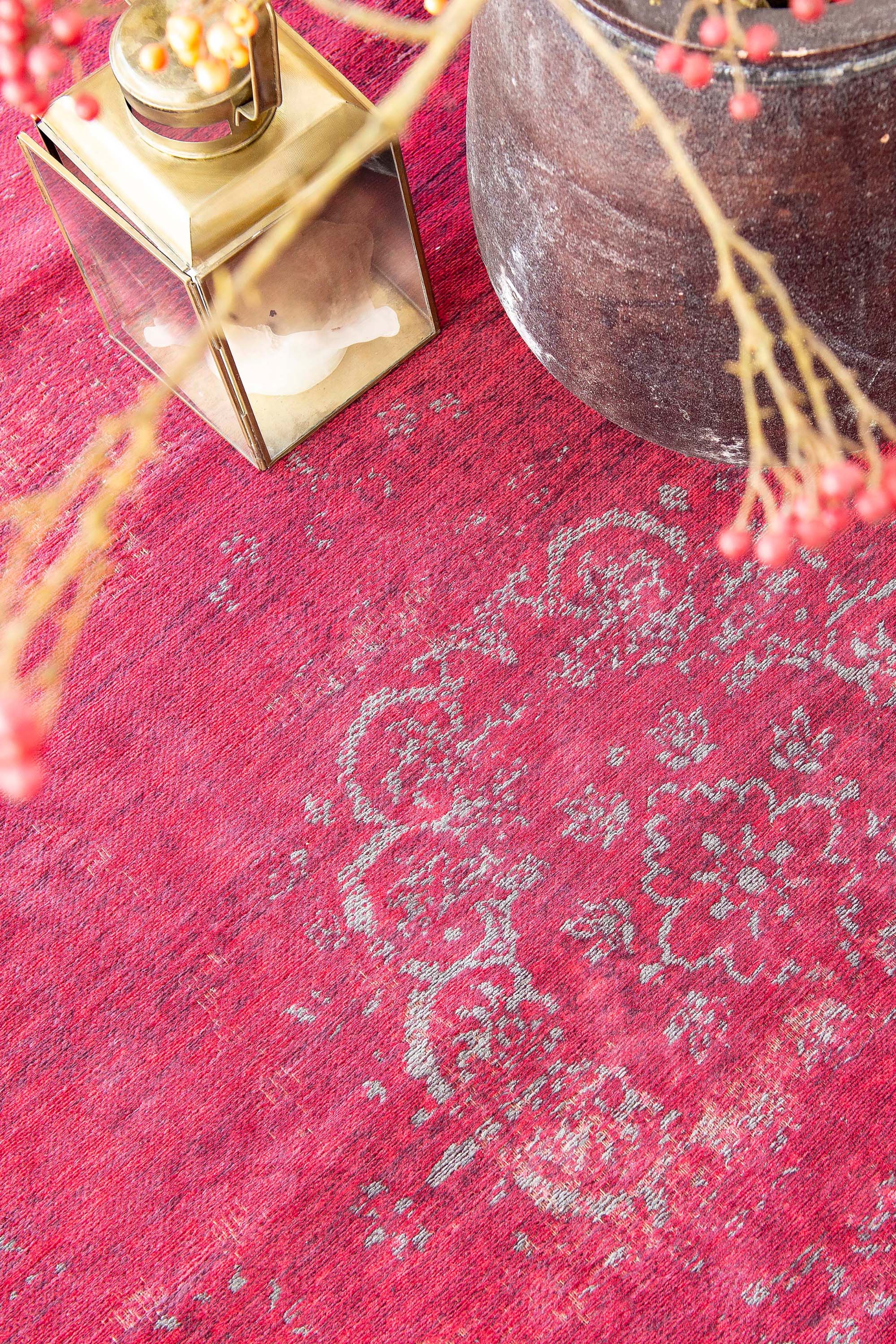 Red rug with faded persian design