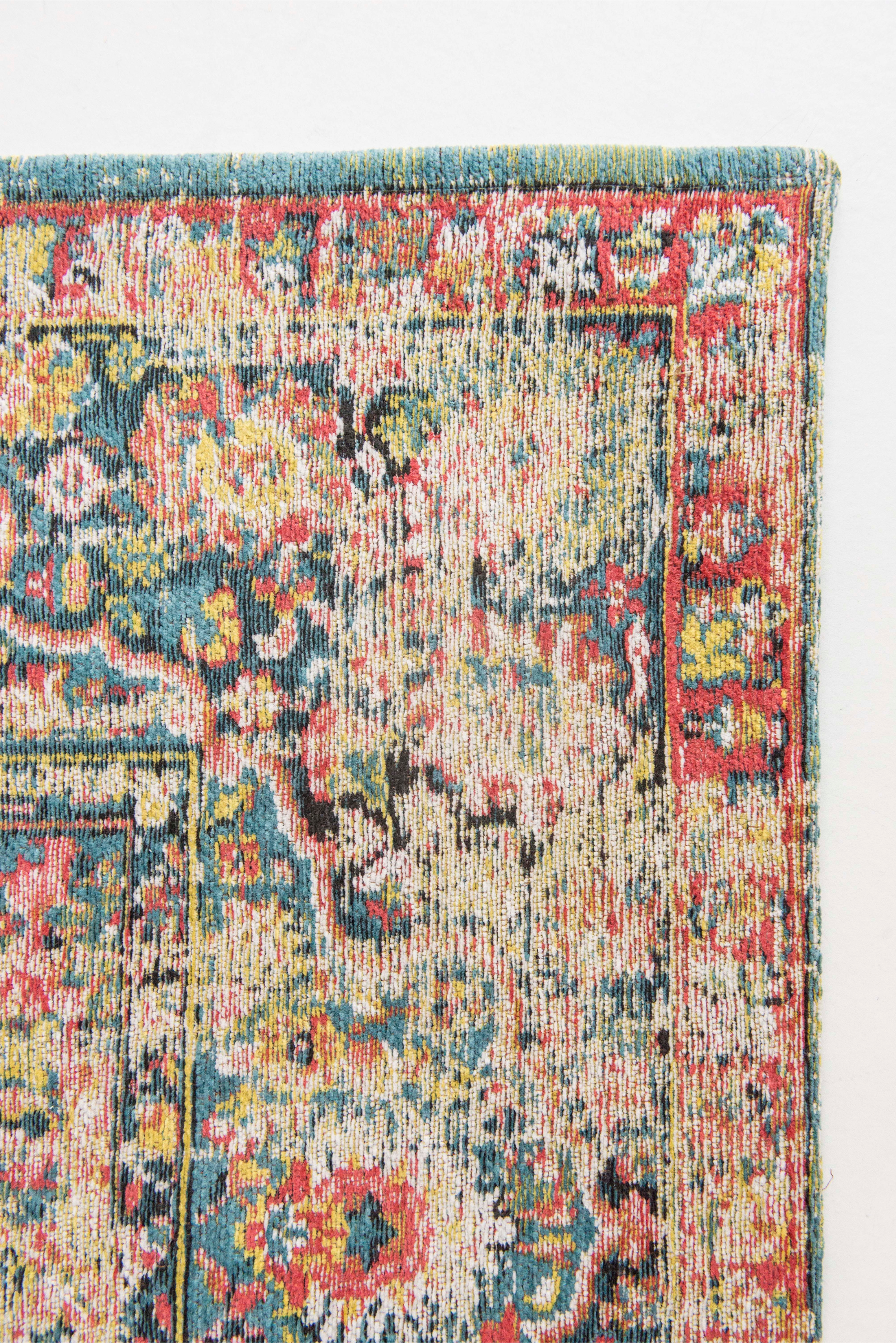 Flatweave rug with faded persian design in blue, red and yellow