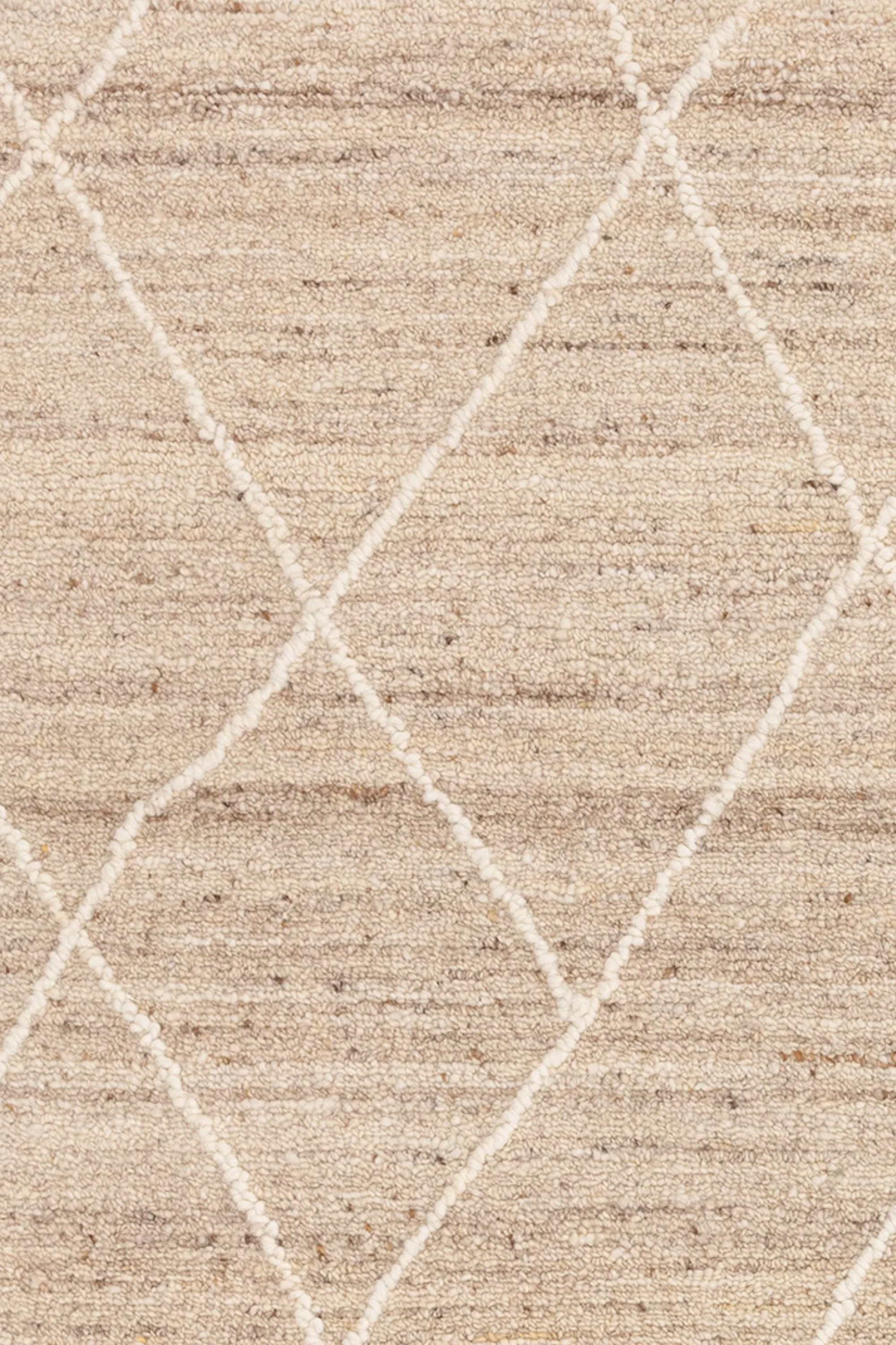 Light brown wool rug with geometric pattern and heathered texture