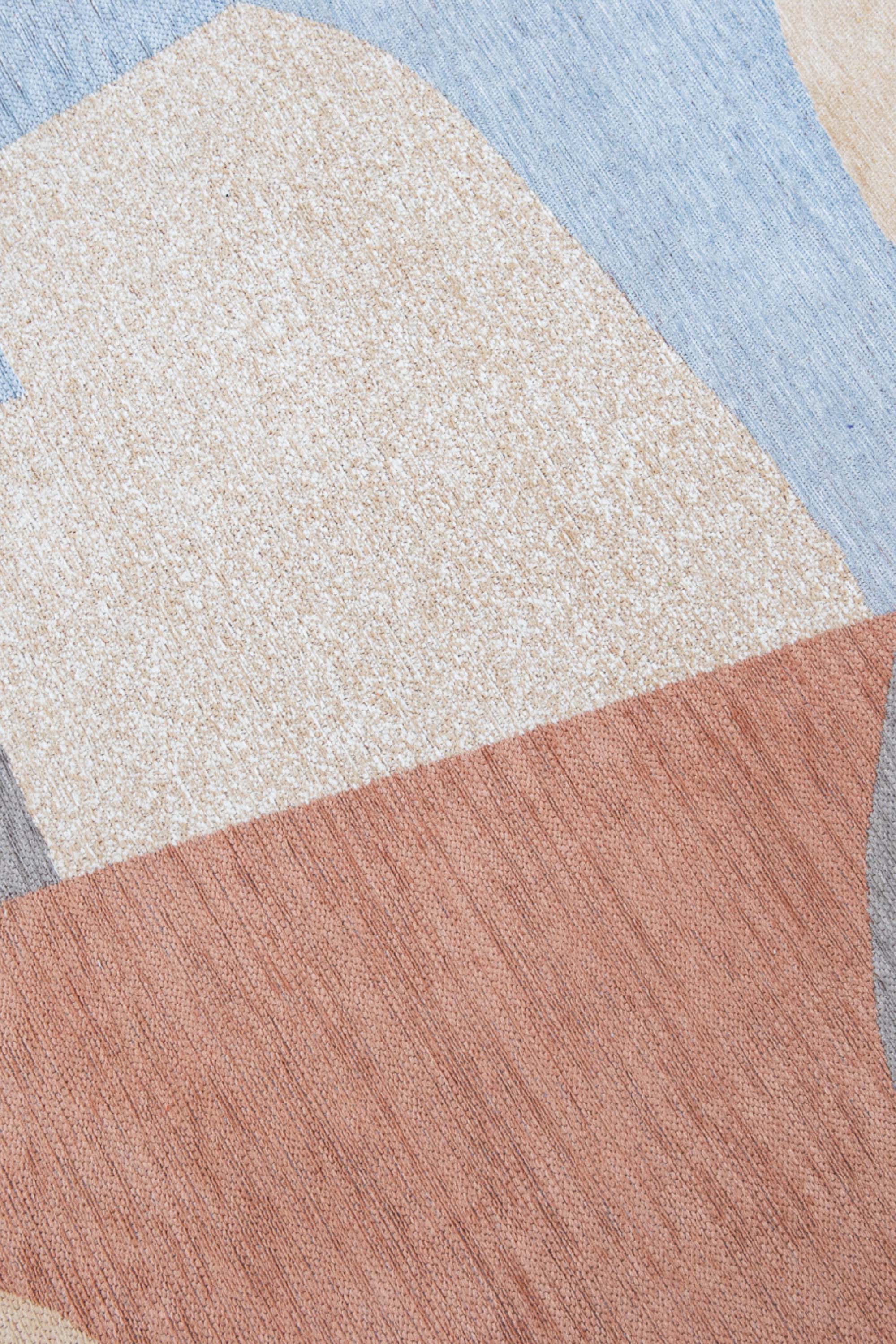 Modern circle rug with red, blue, white, and grey abstract pattern