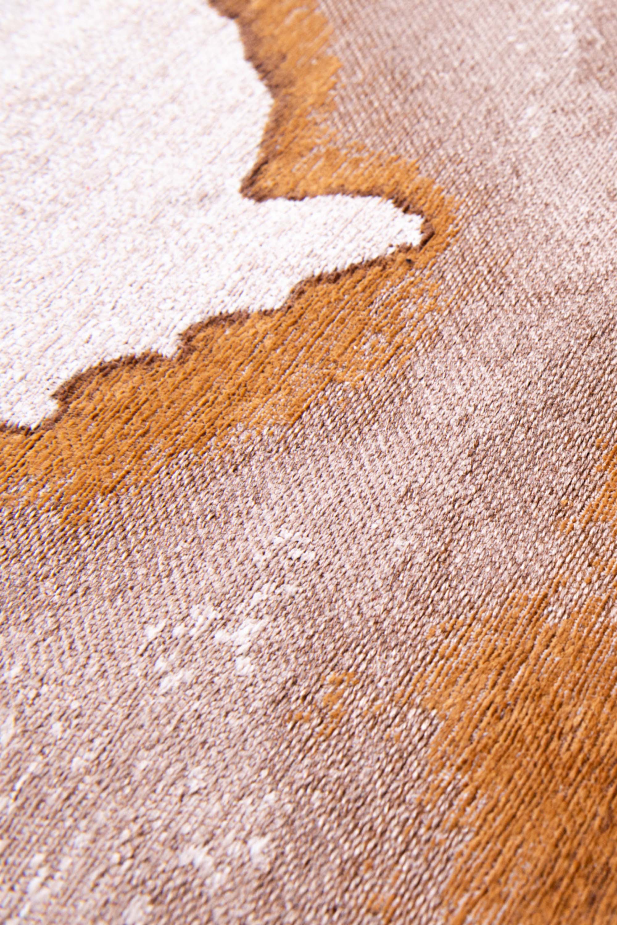 Modern circle rug with brown abstract shoreline pattern
