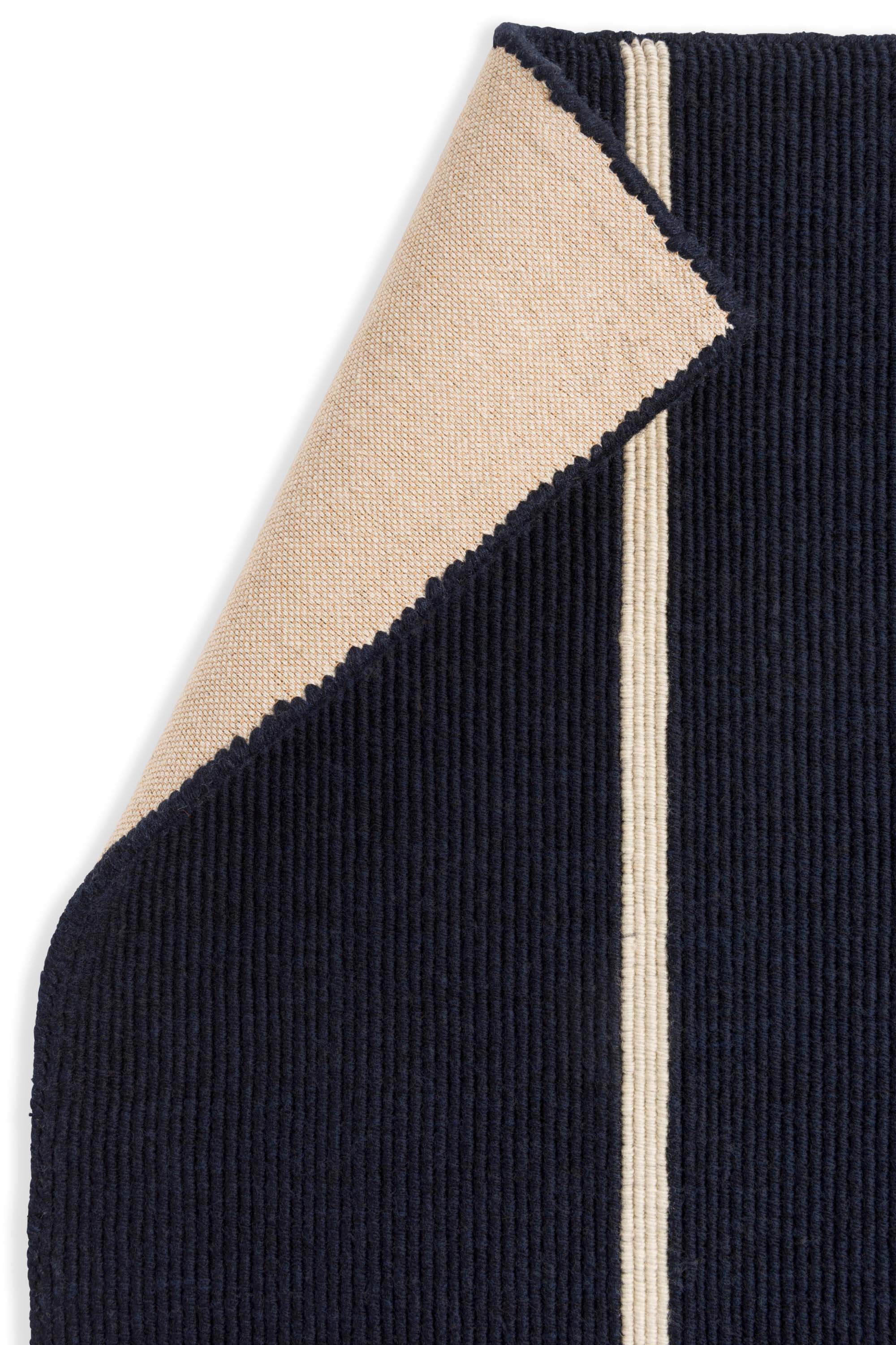 Geometric rug with blue linear pattern