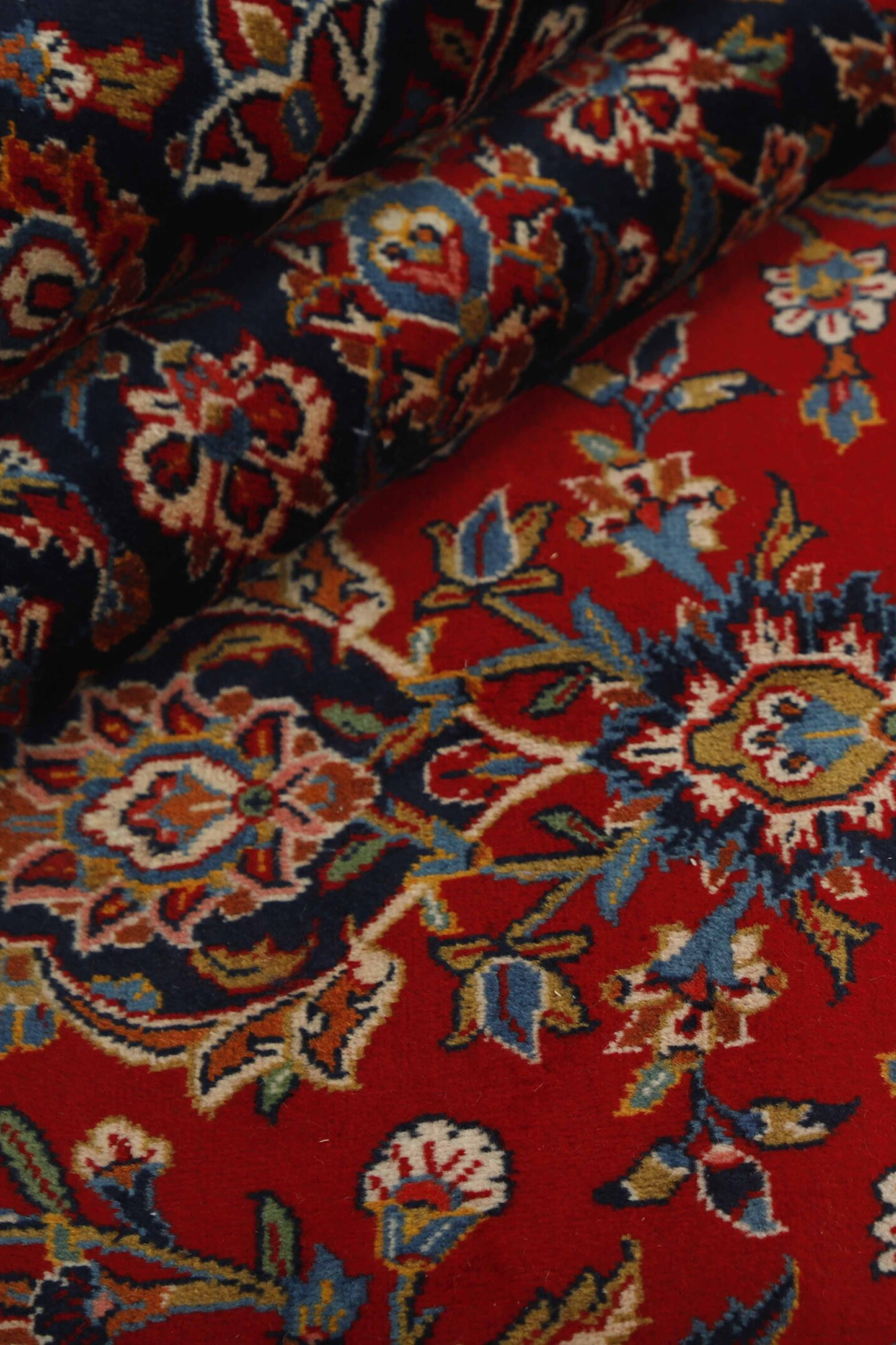 Authentic persian rug with traditional floral design in red and blue