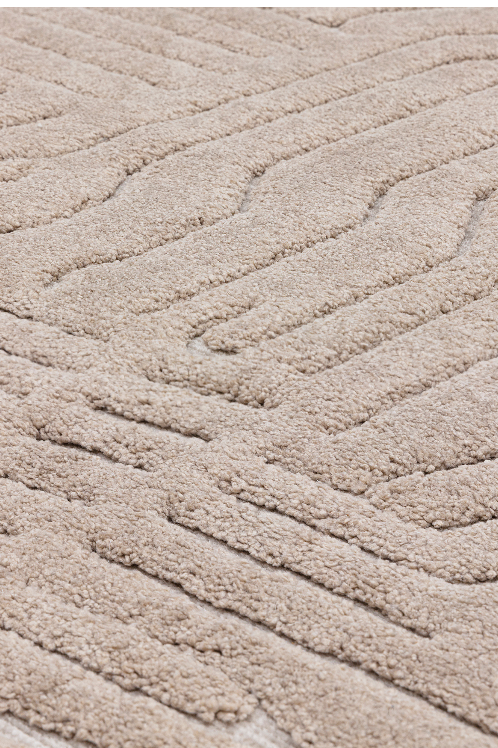 Beige rug with high-low pile and minimal geometric pattern