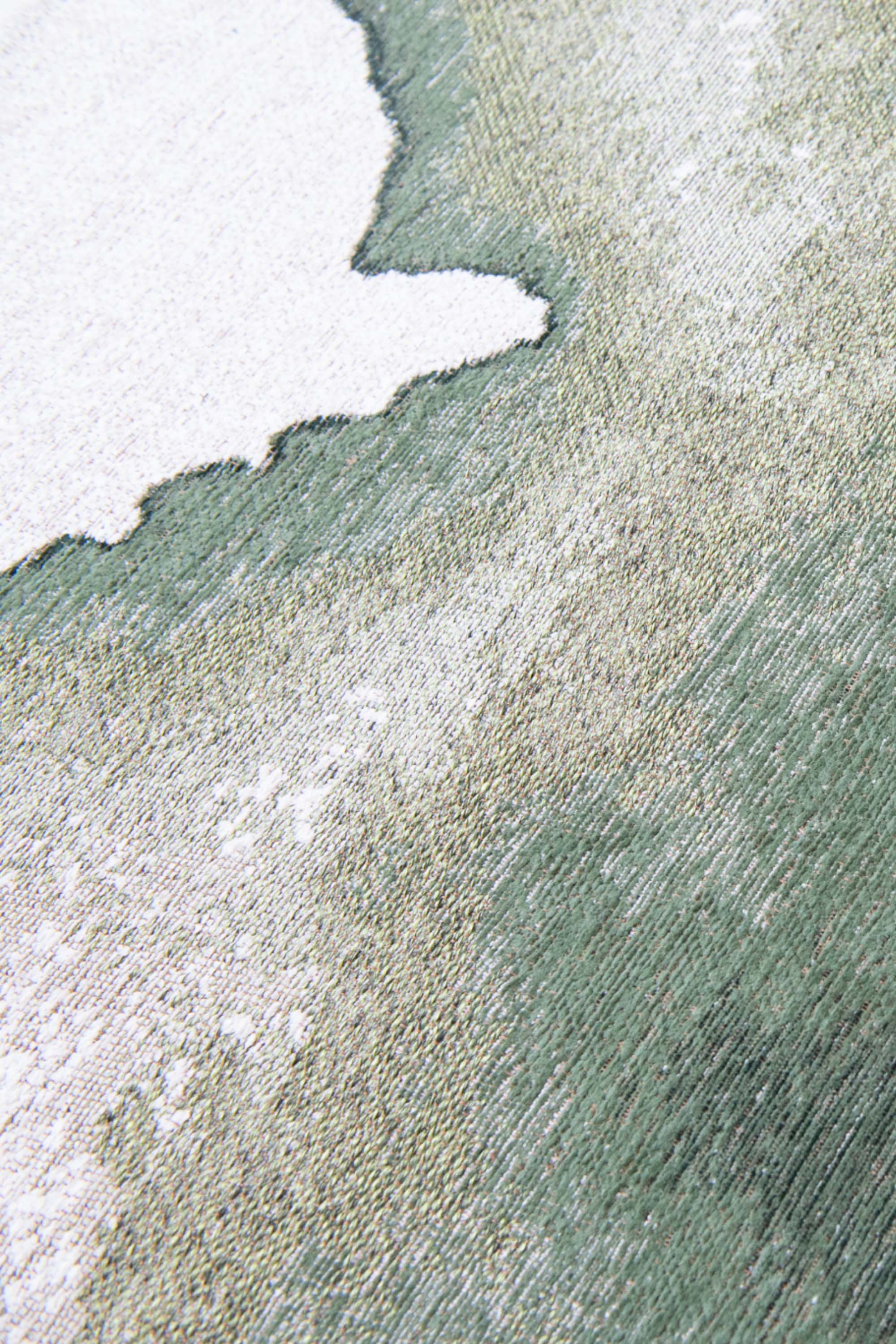 Modern circle rug with green abstract shoreline pattern