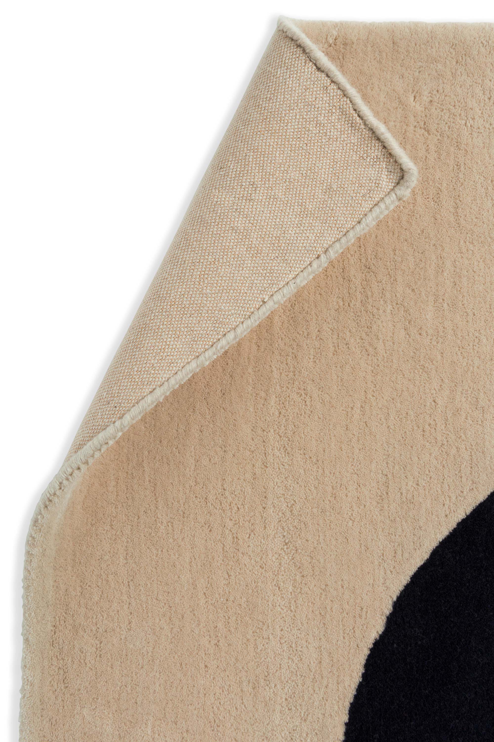 Beige and green rug with cream blue pattern