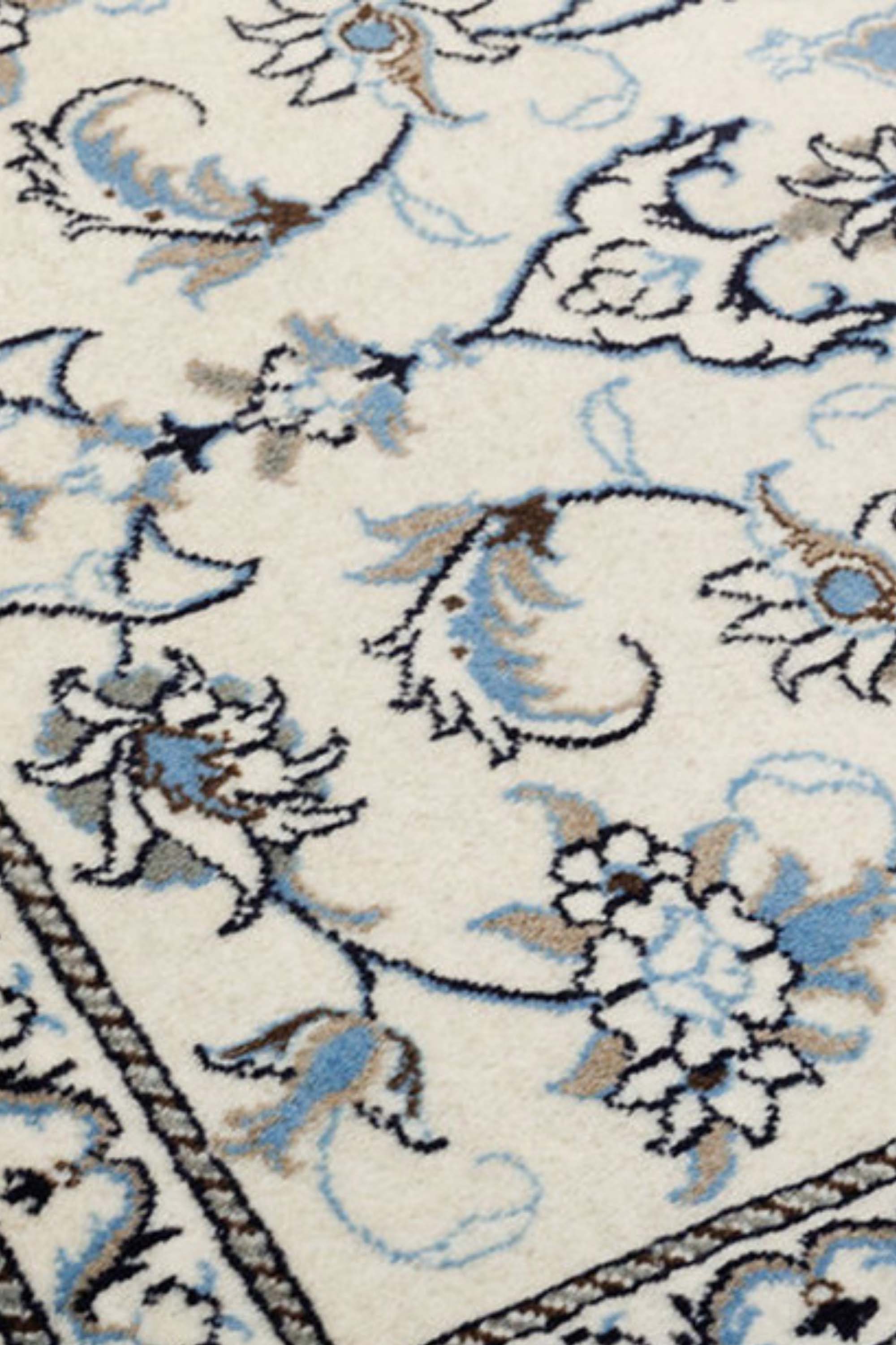 authentic persian rug with a traditional floral design in blue, ivory and cream
