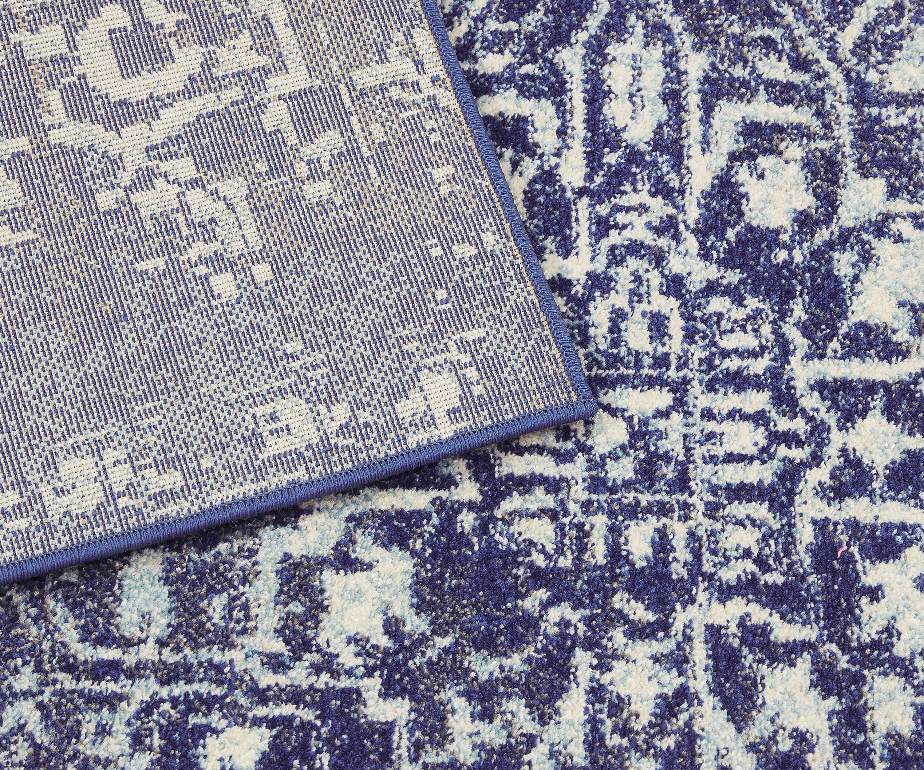 navy blue rug with an oriental design