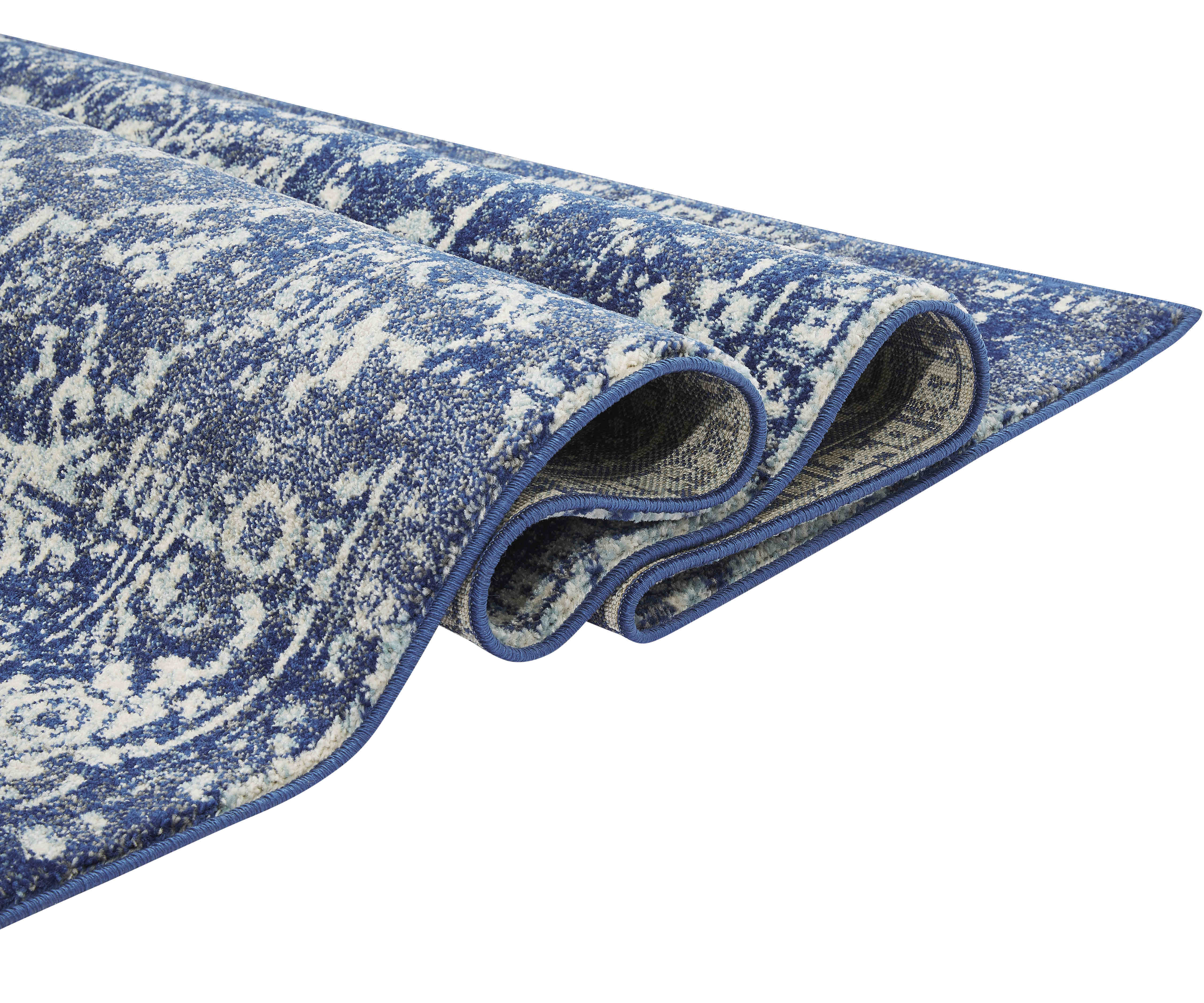 navy blue rug with an oriental design