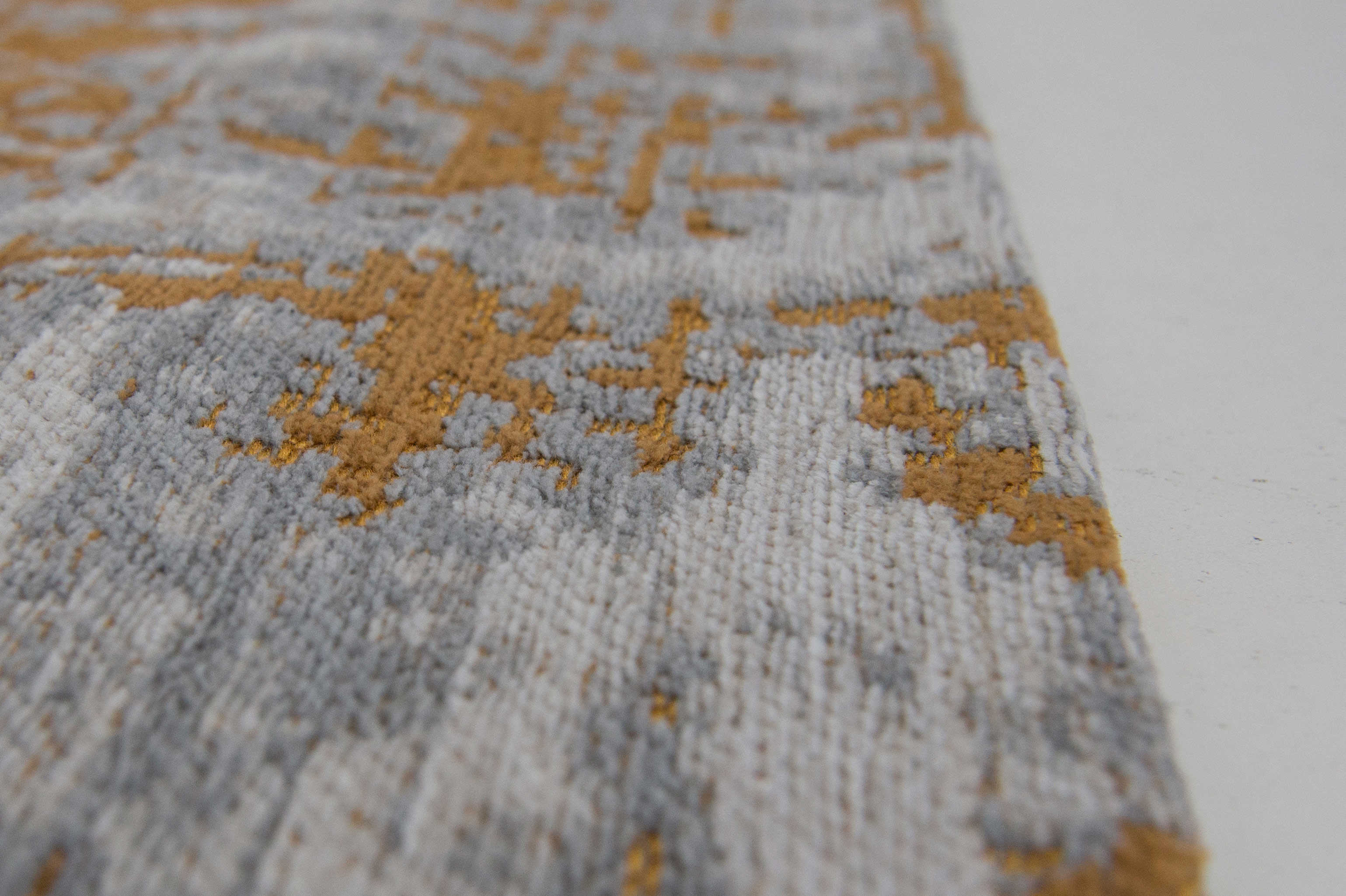 White flatweave rug with grey and yellow abstract pattern