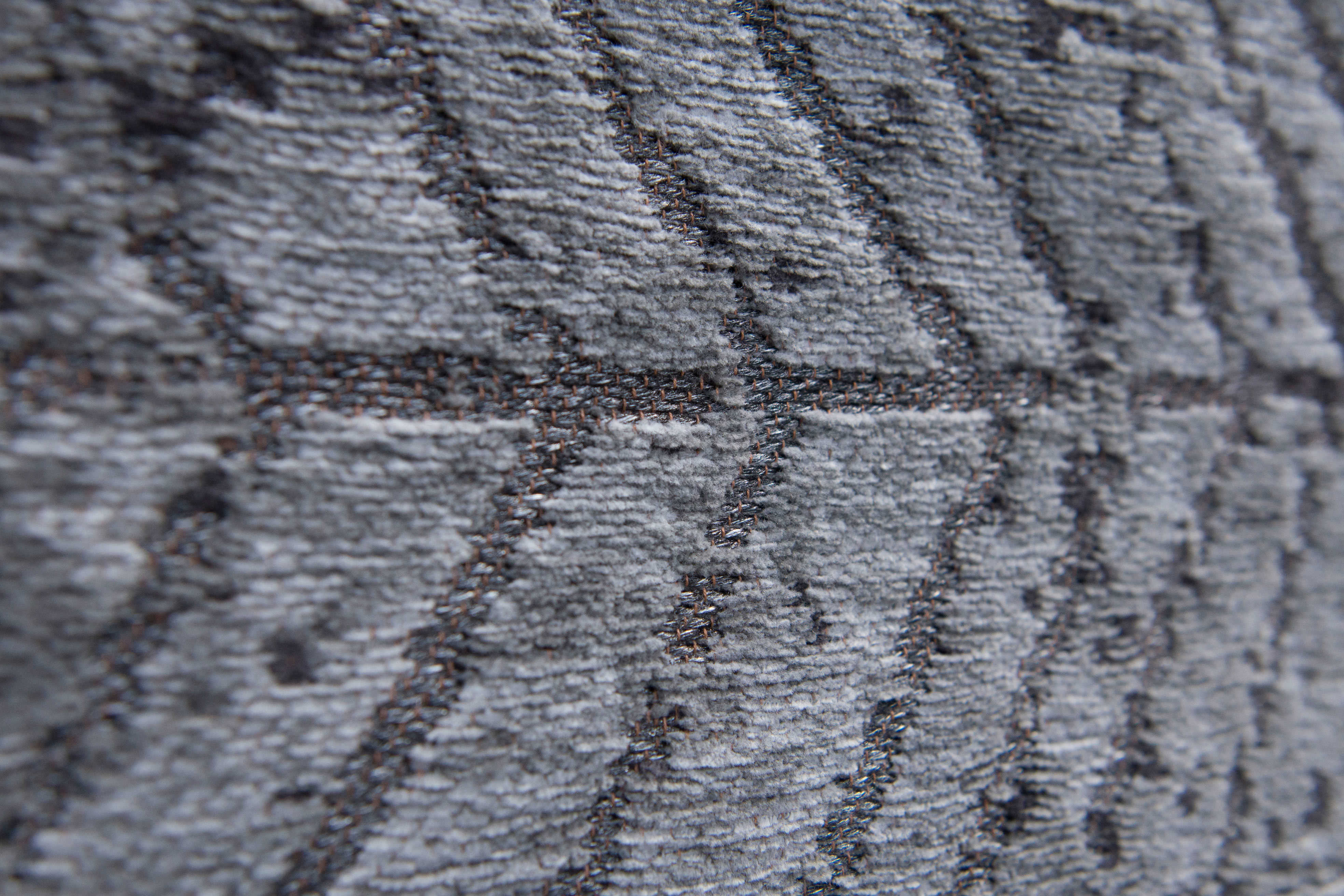 Black flatweave rug with faded grey chevron pattern