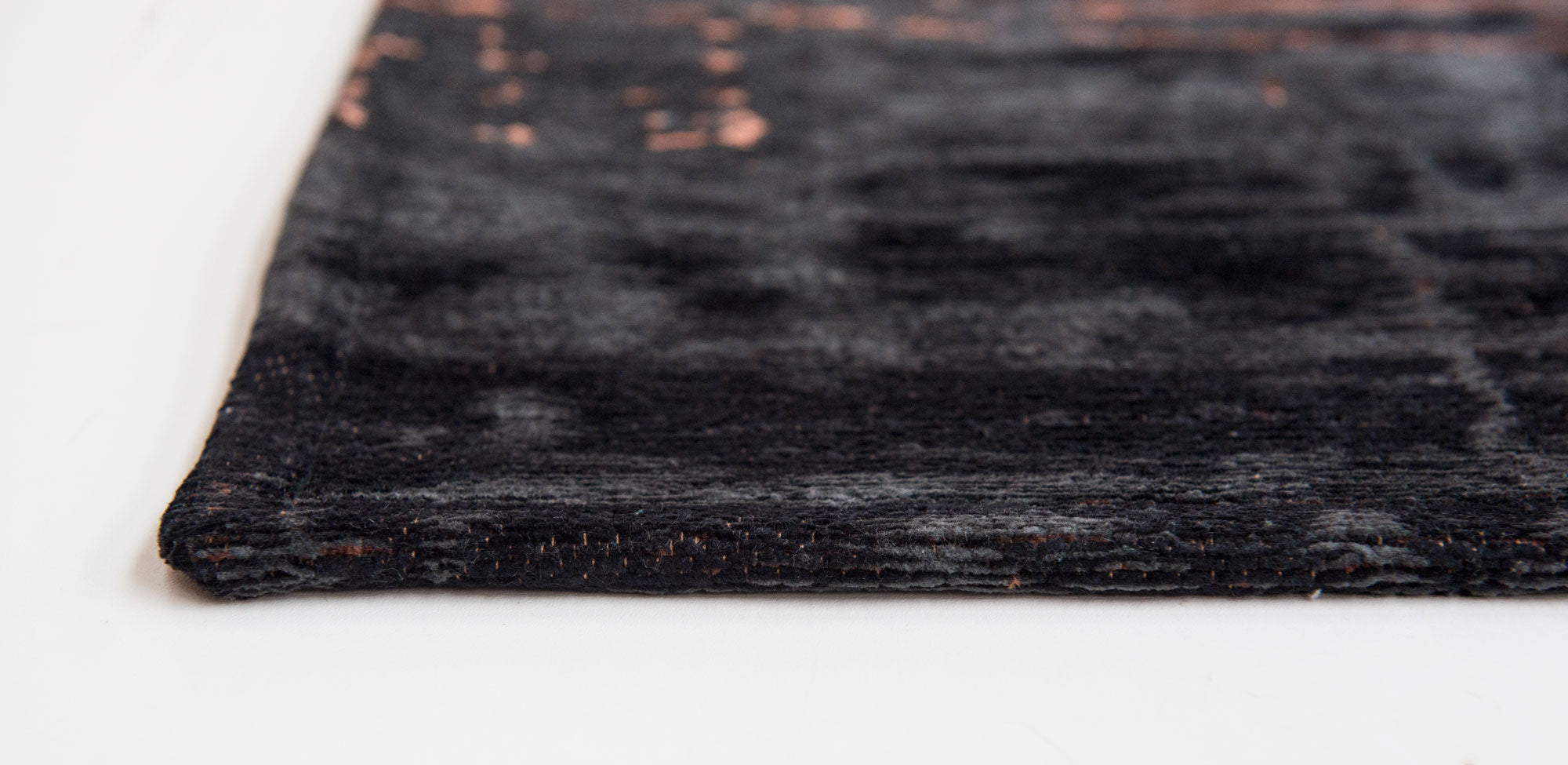 Black flatweave rug with copper brown abstract pattern