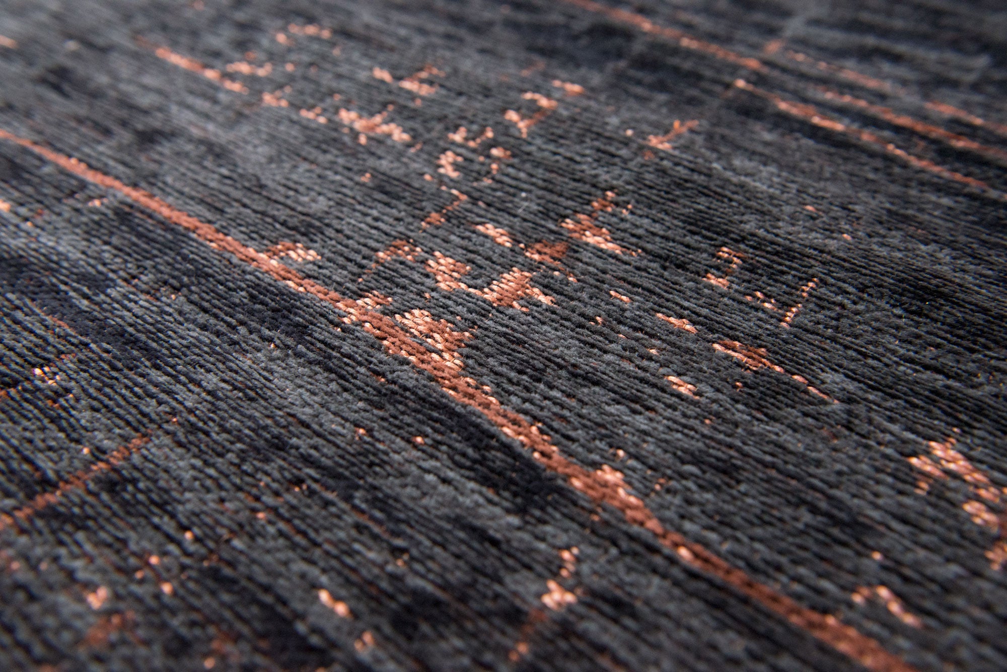 Black flatweave rug with copper brown abstract pattern
