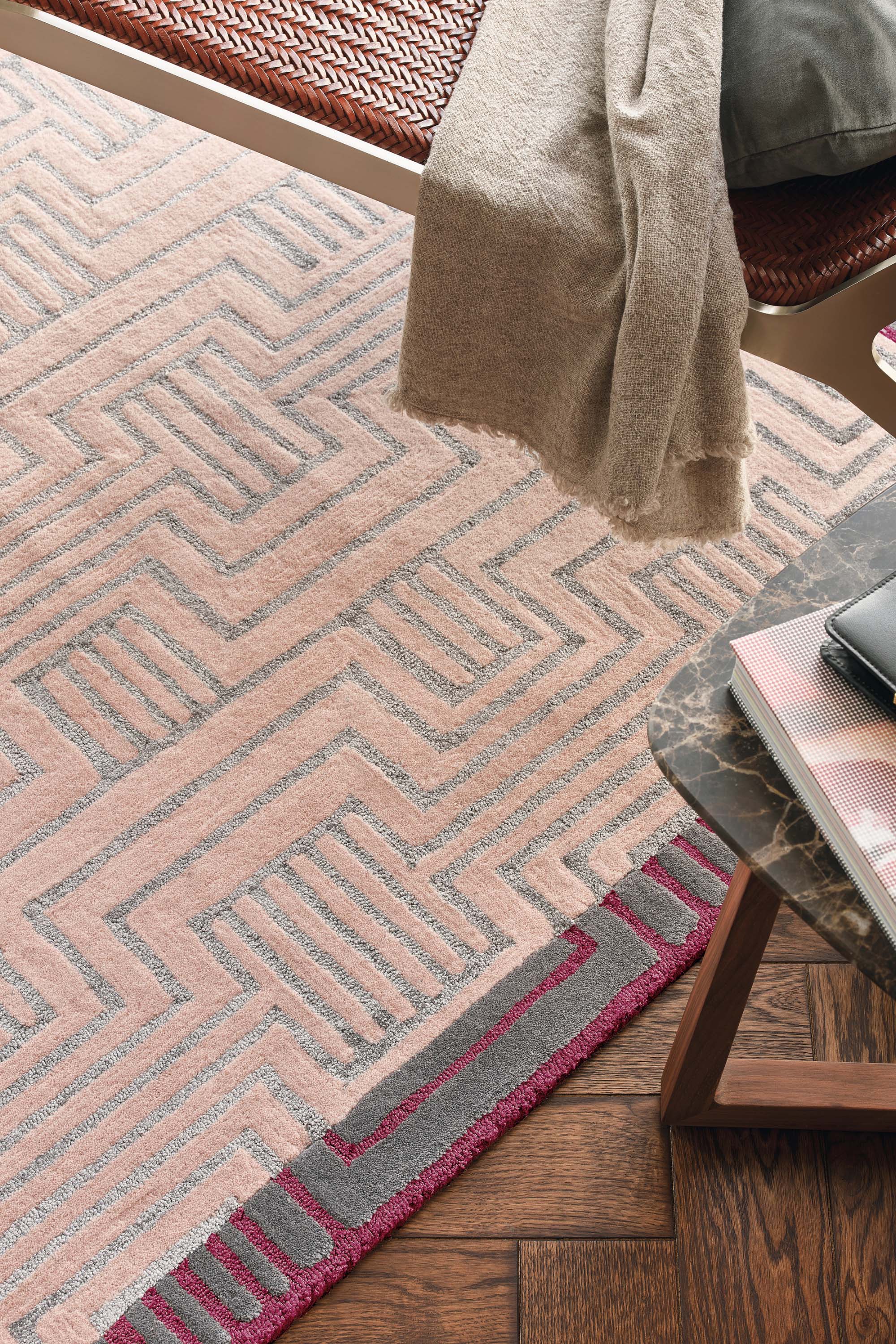 Rectangular pink rug with burgundy border and grey art deco pattern