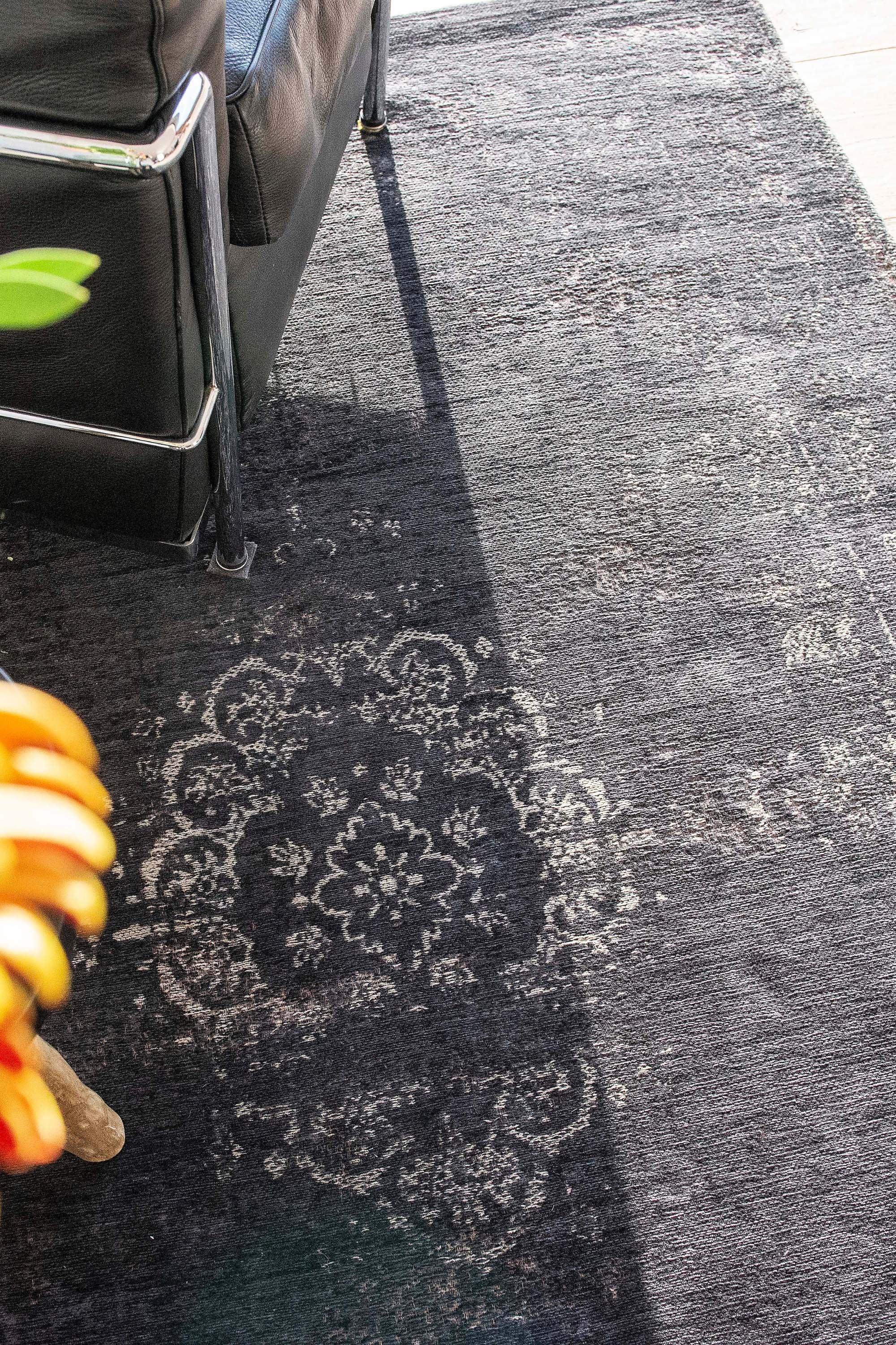 Black flatweave rug with faded persian design
