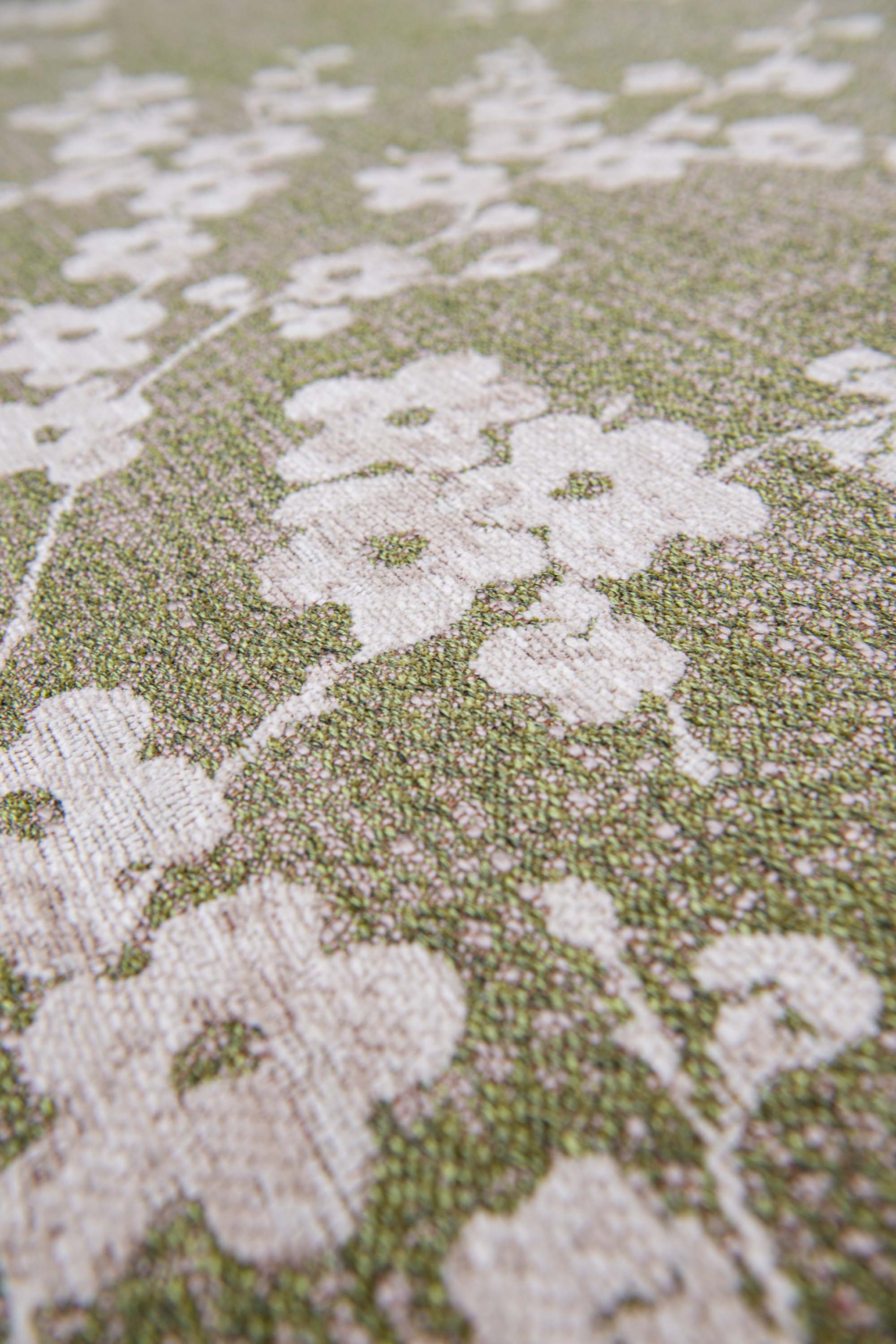 Modern abstract circle rug with subtle green floral pattern