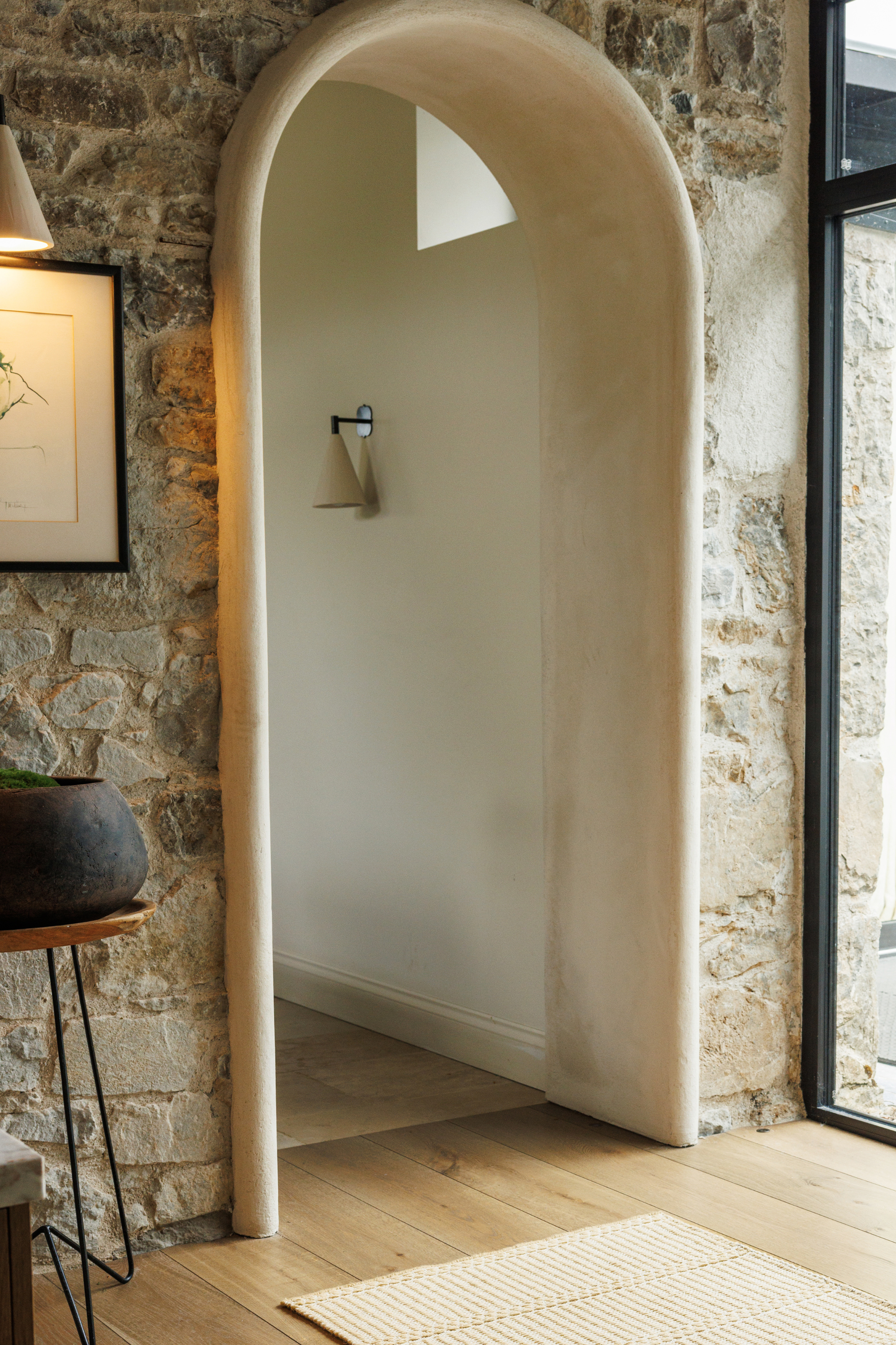 wool and cotton runner rug in a golden straw tone featuring a design inspired by ancient irish script placed in a hallway