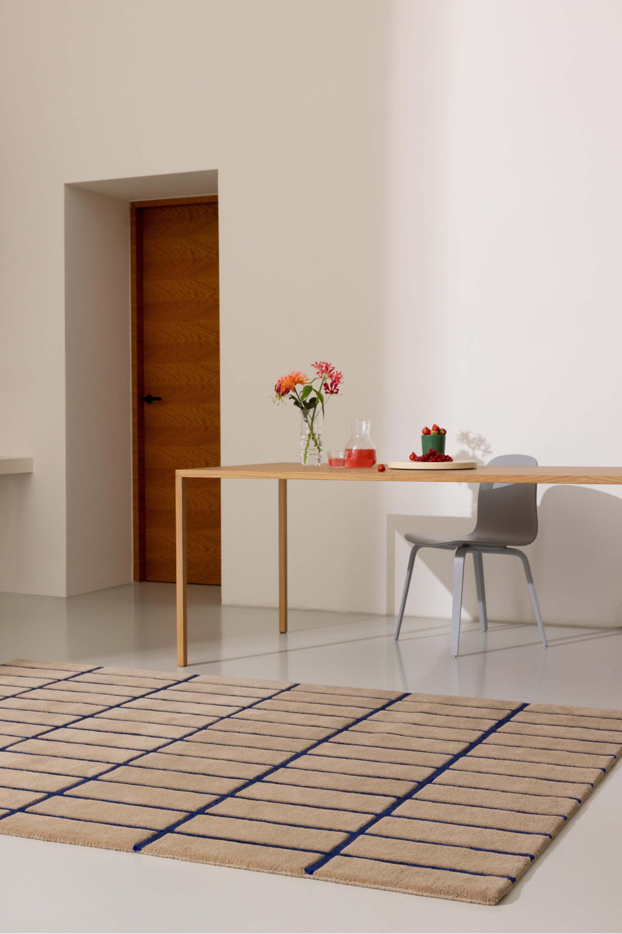 Geometric rug with blue grid pattern