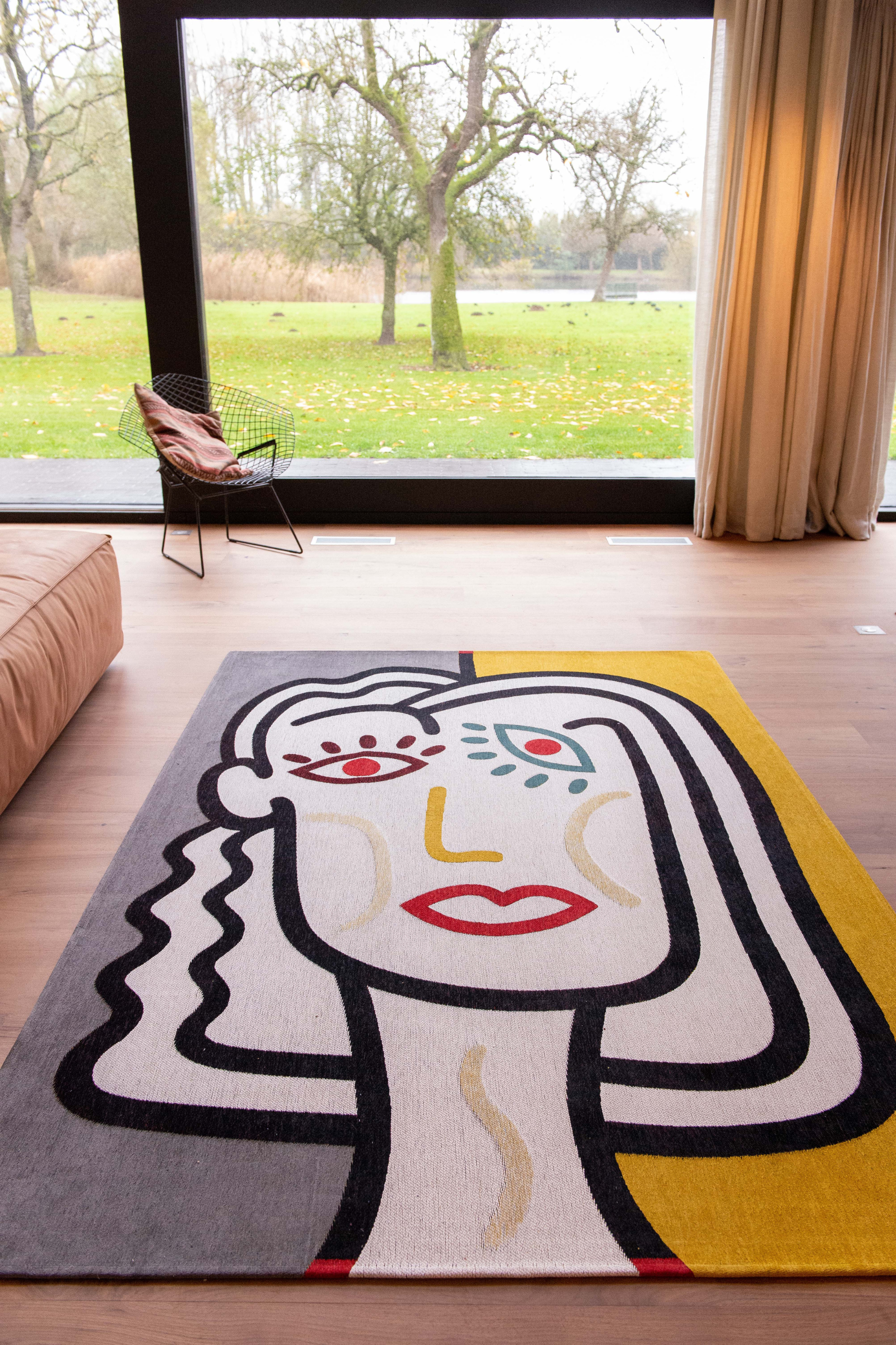 yellow, blue and red rug with an abstract face