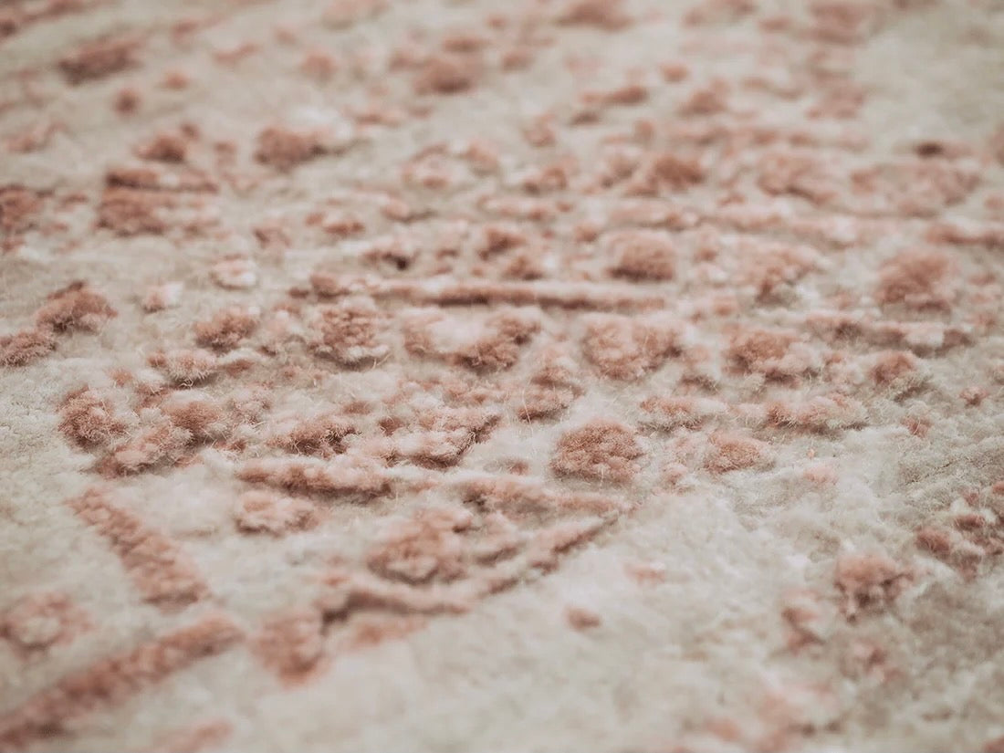 Pink and beige abstract area rug