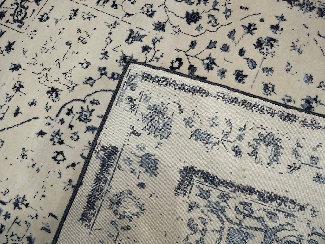 cream and blue oriental rug with a floral design