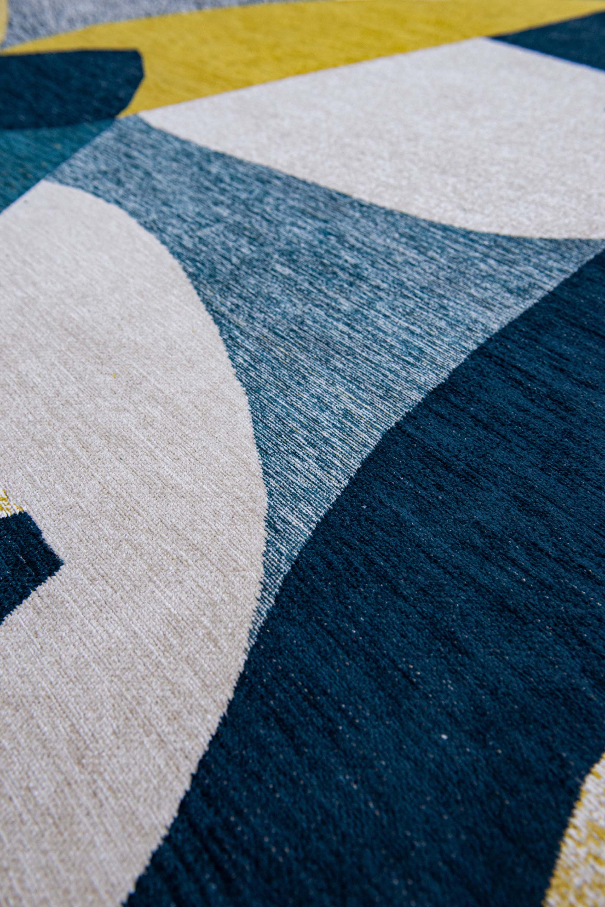 Modern circle rug with blue and yellow abstract pattern