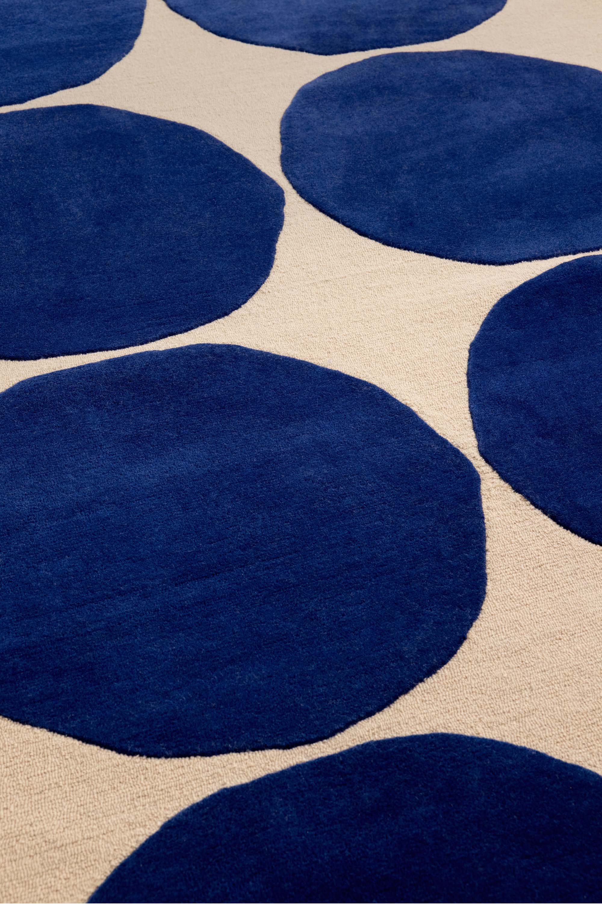 Beige rug with blue repeated circle pattern