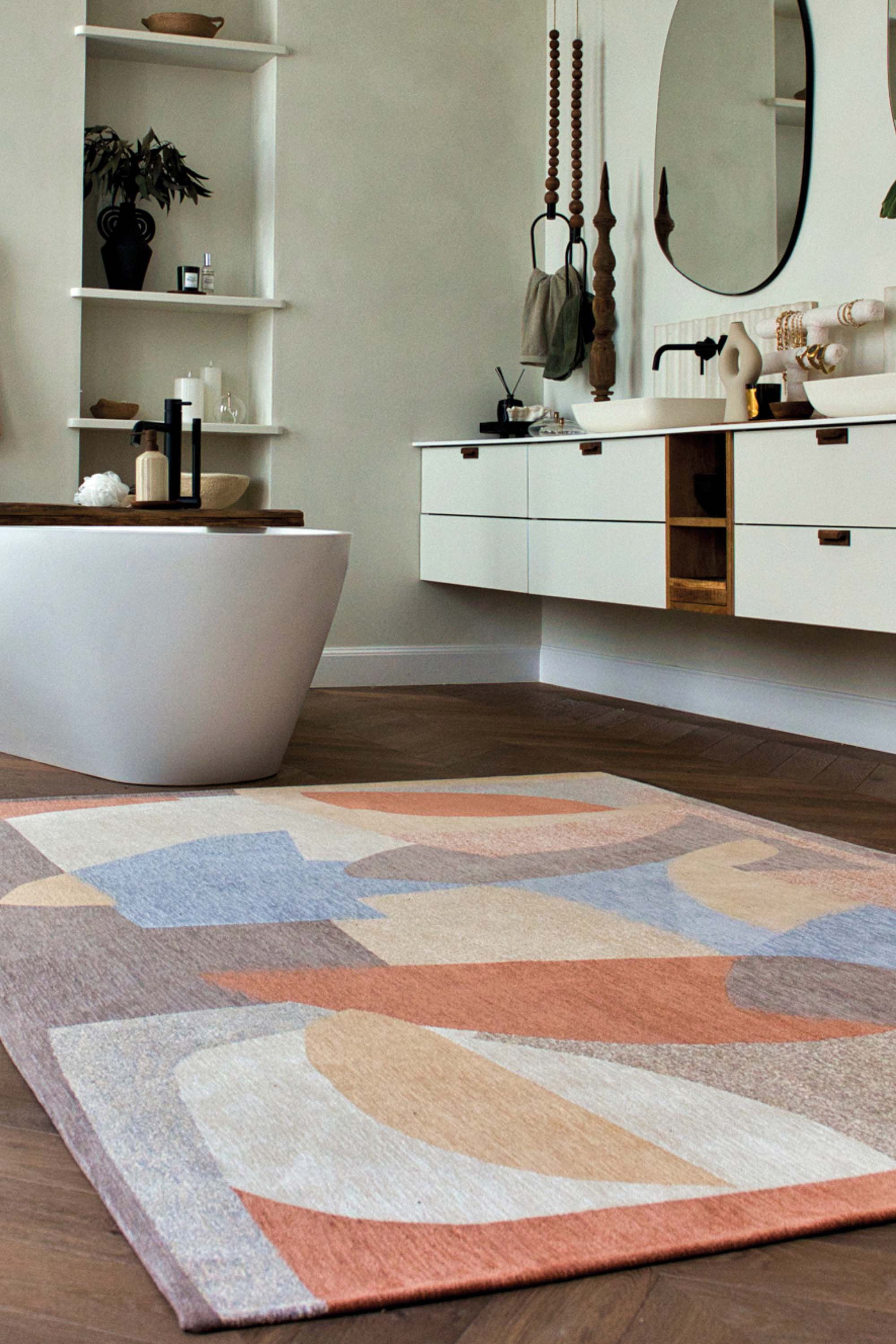 Modern circle rug with red, blue, white, and grey abstract patternModern circle rug with red, blue, white, and grey abstract pattern