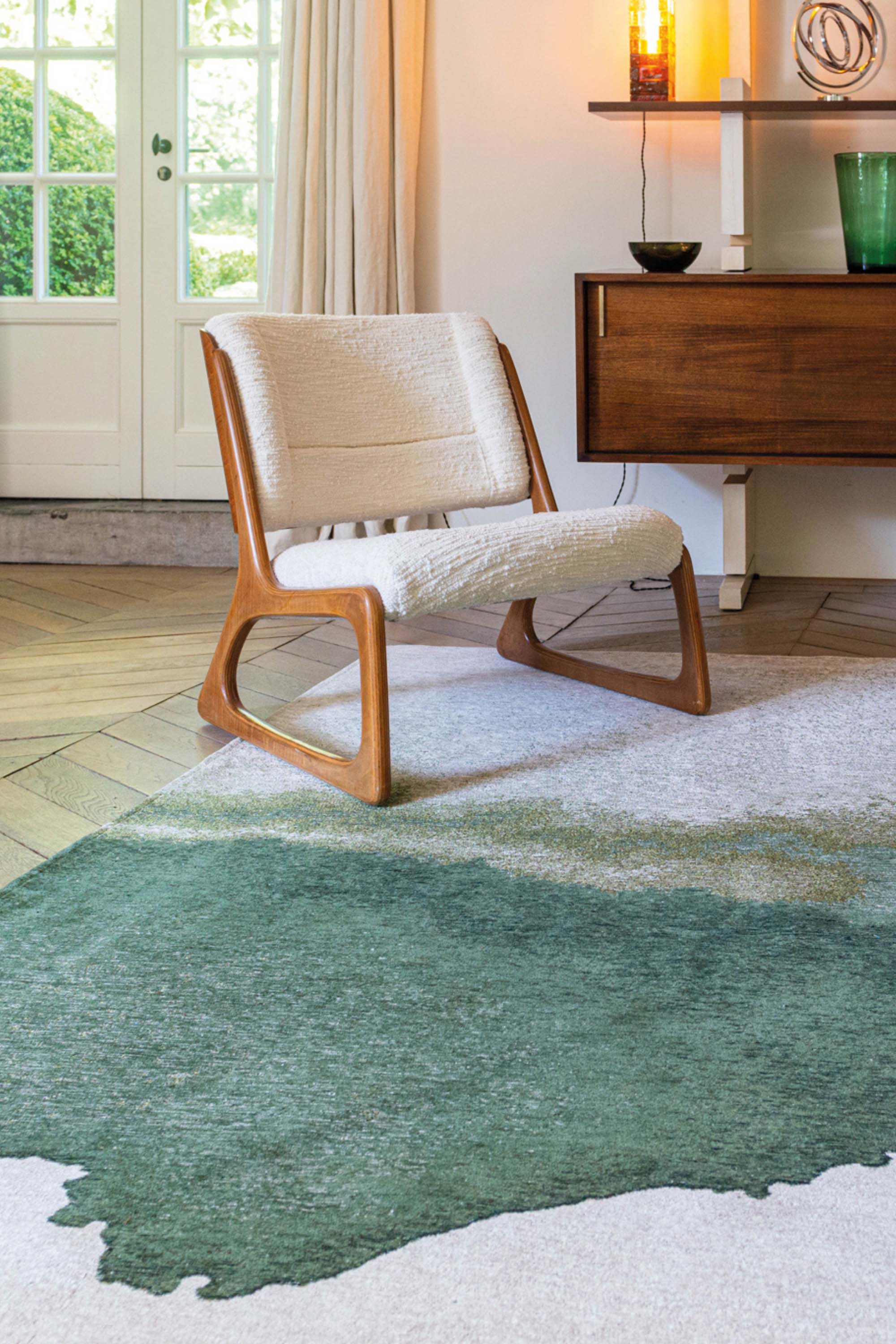 Modern rug with green abstract shoreline pattern