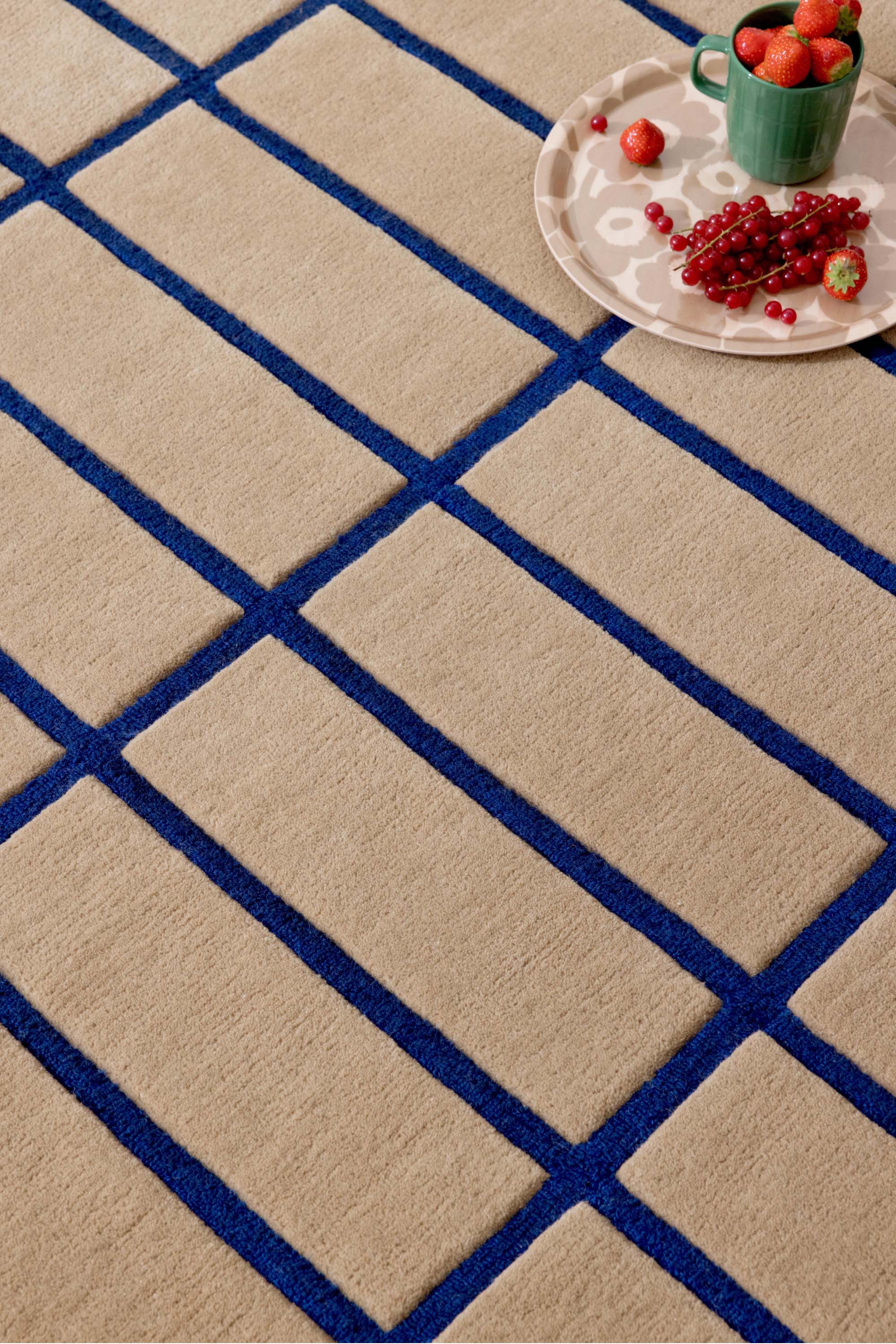 Geometric rug with blue grid pattern