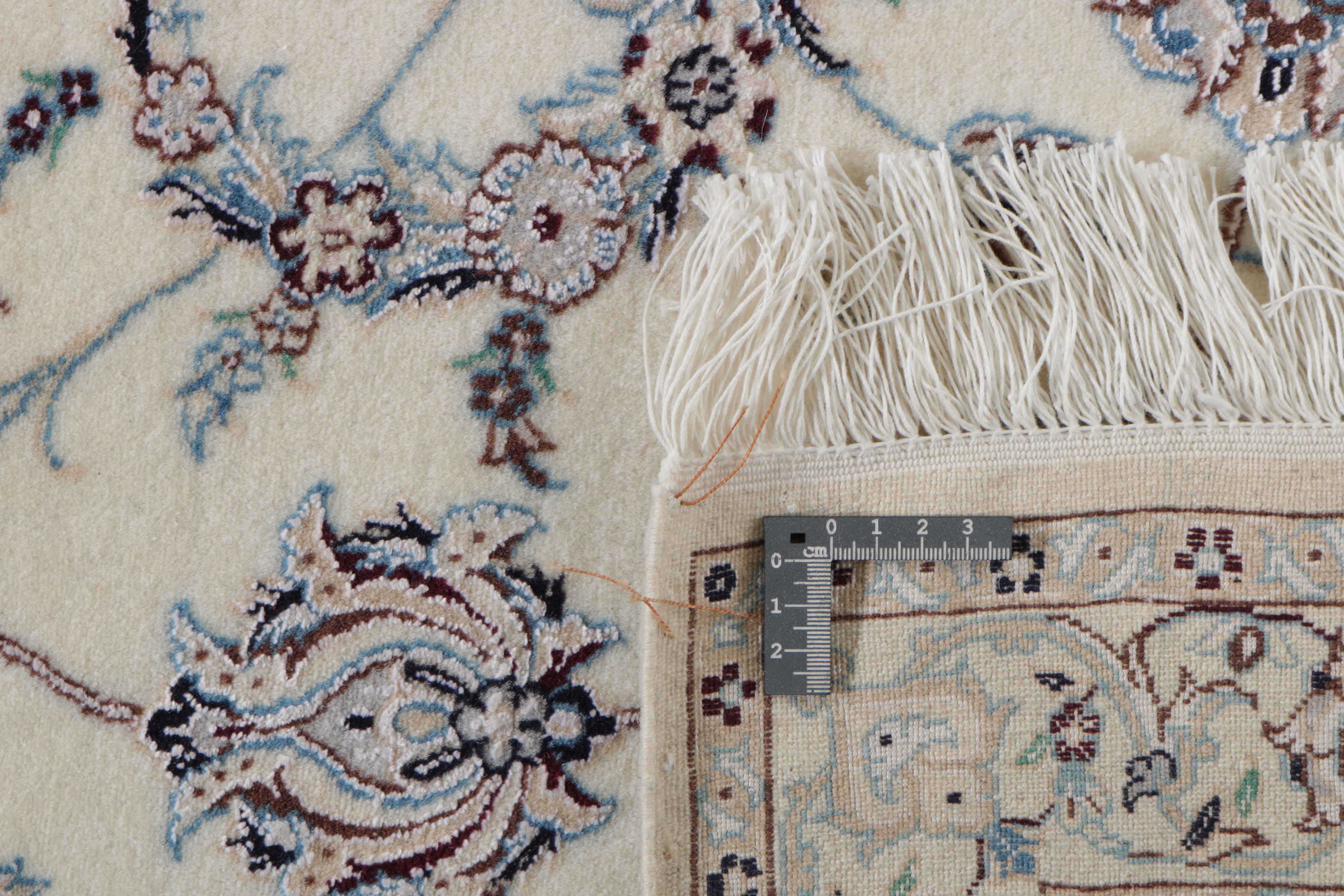 Authentic persian rug with traditional floral design in ivory and black