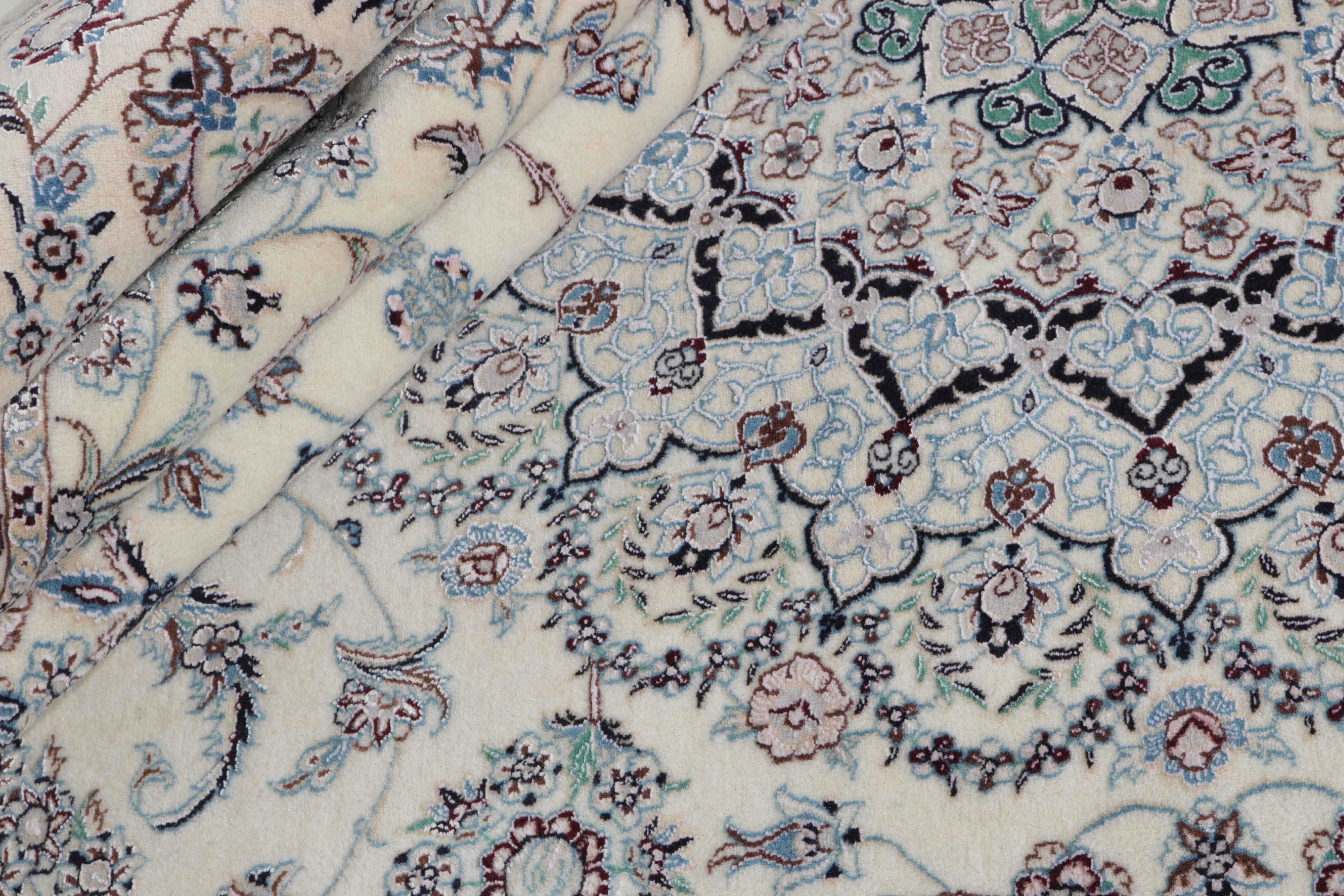 Authentic persian rug with traditional floral design in ivory and black