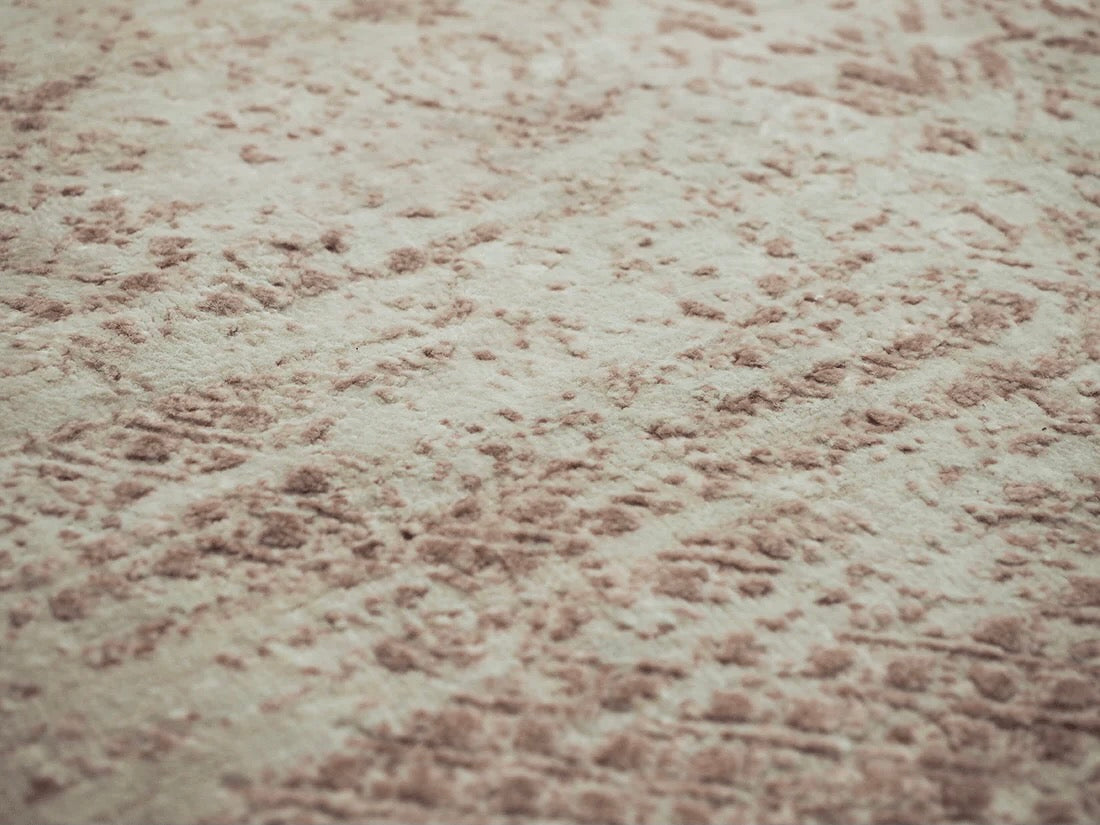 Pink and beige abstract area rug