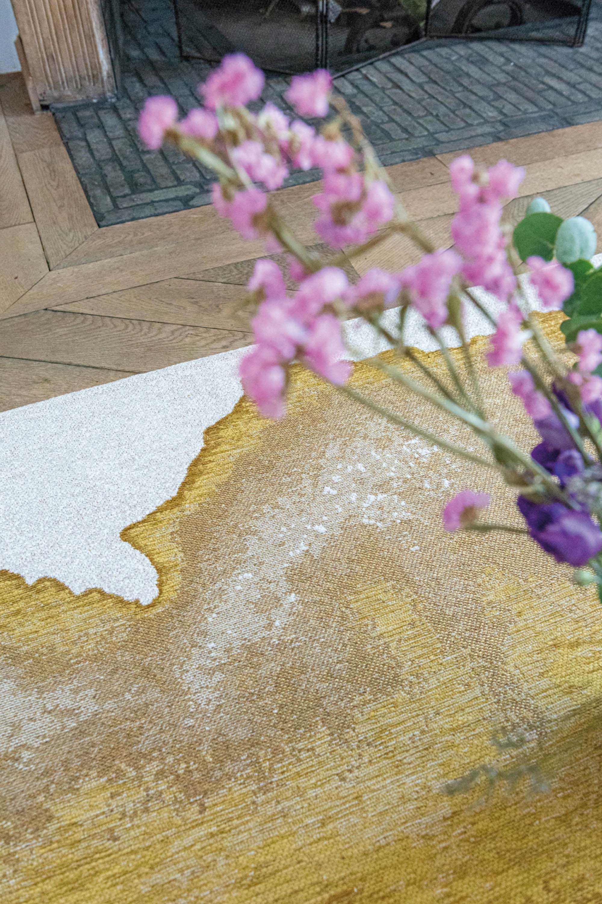 Modern rug with gold abstract shoreline pattern