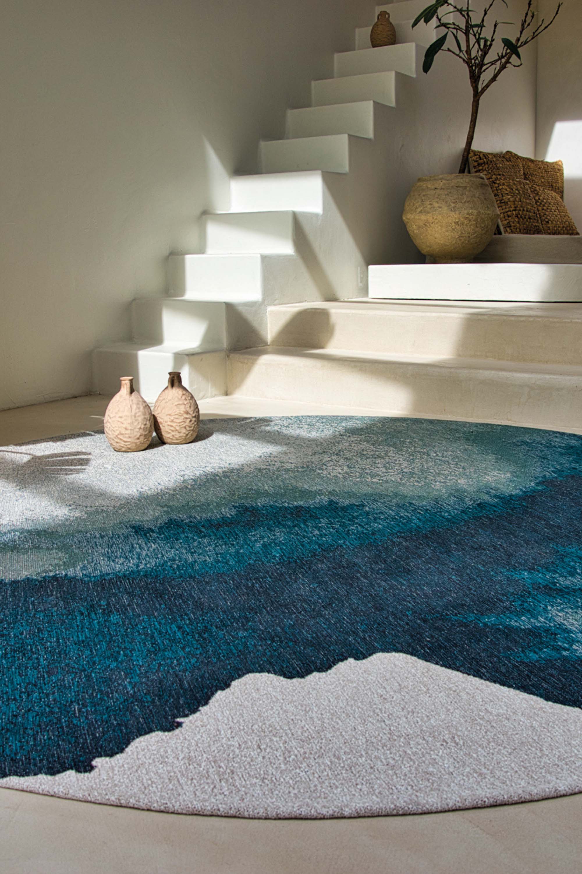 Modern circle rug with blue abstract shoreline pattern