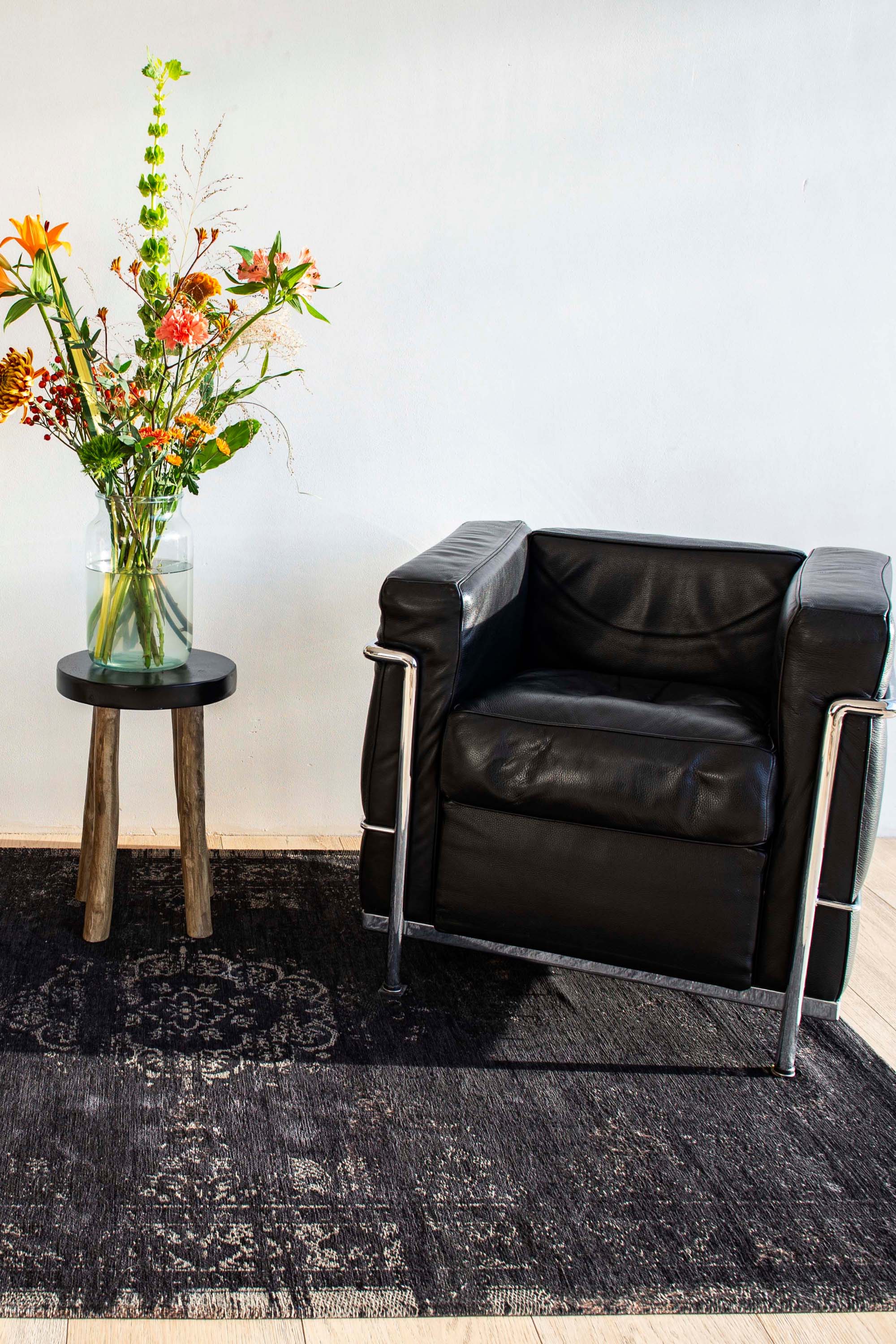 Black flatweave rug with faded persian design