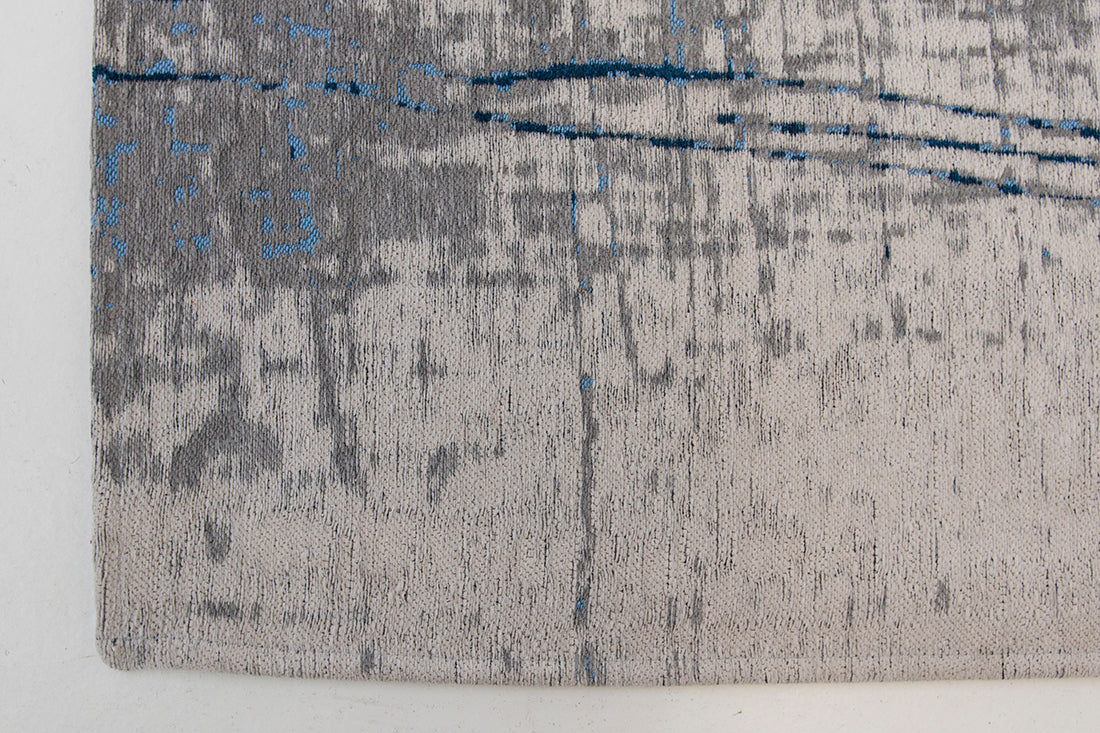 White flatweave rug with grey and blue abstract pattern