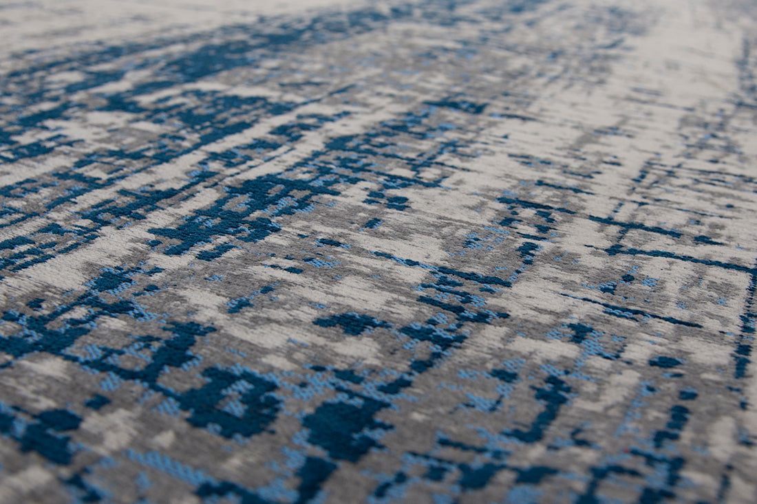 White flatweave rug with grey and blue abstract pattern