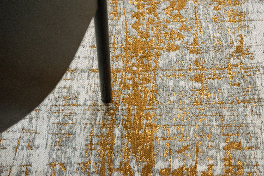 White flatweave rug with grey and yellow abstract pattern