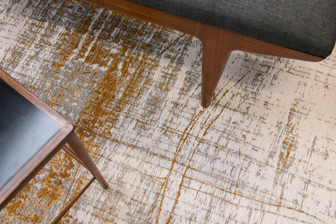White flatweave rug with grey and yellow abstract pattern