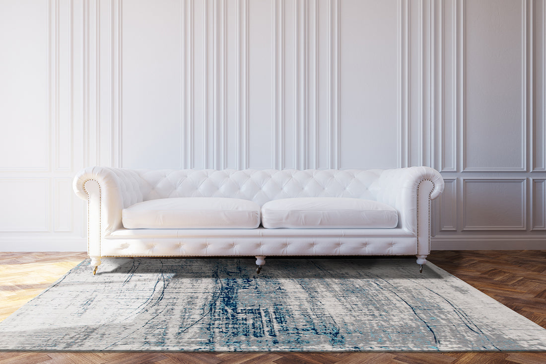 White flatweave rug with grey and blue abstract pattern