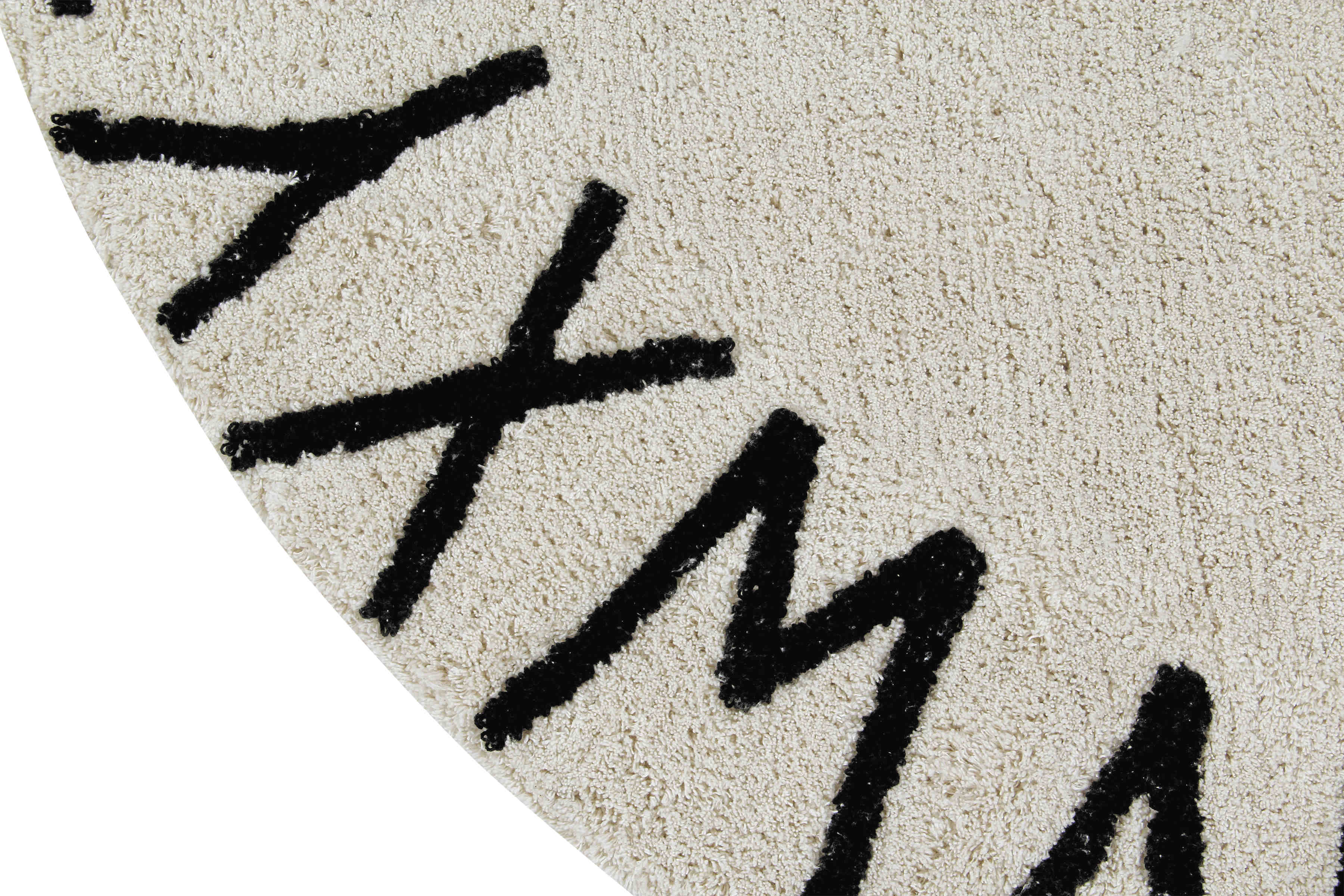 Circular white cotton rug decorated with a black alphabet border